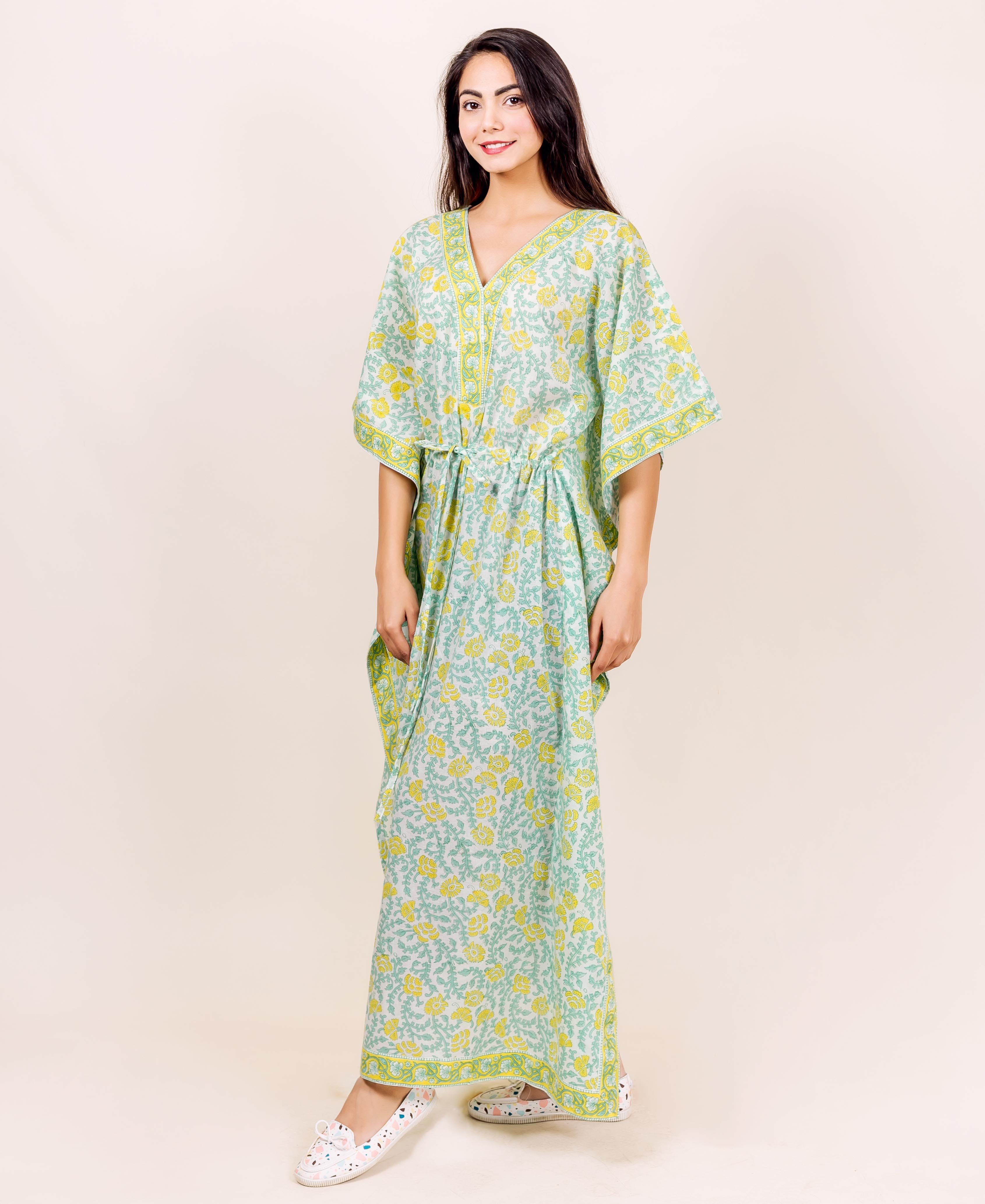 Front view of model in full-length light green and yellow floral block printed kaftan lounge wear.