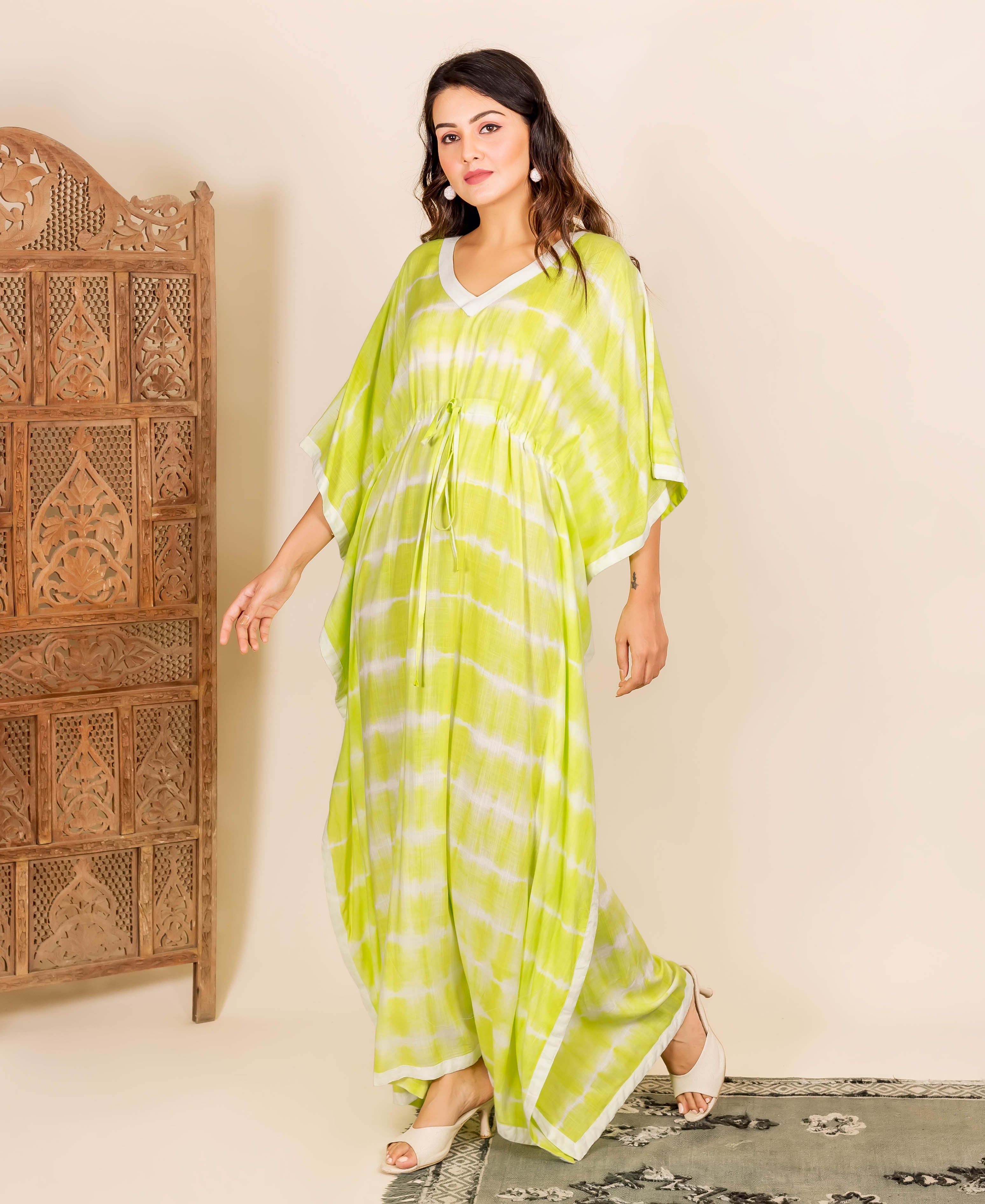 Model wearing a lime and white tie-dye kaftan with an adjustable drawstring waist.