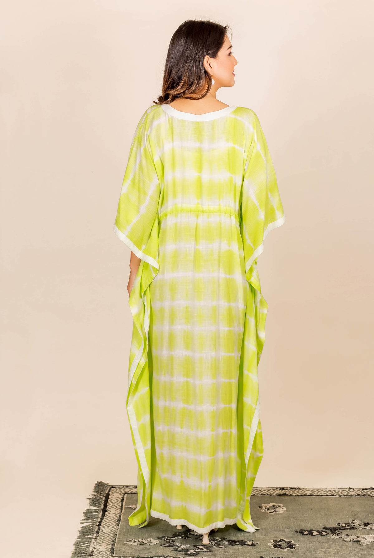 Lime green and white tie-dye kaftan with adjustable waistline and white trim.