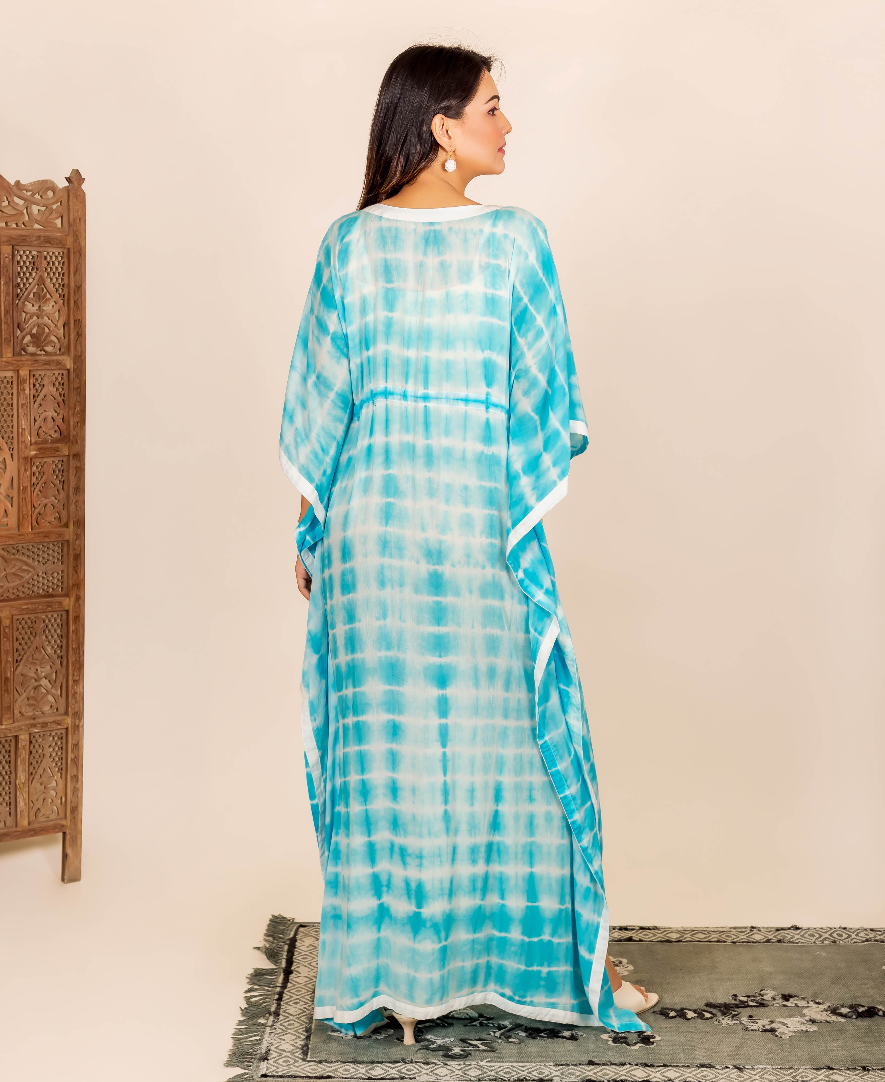 Back view of model in an aqua and white tie-dye full-length kaftan with adjustable waist.