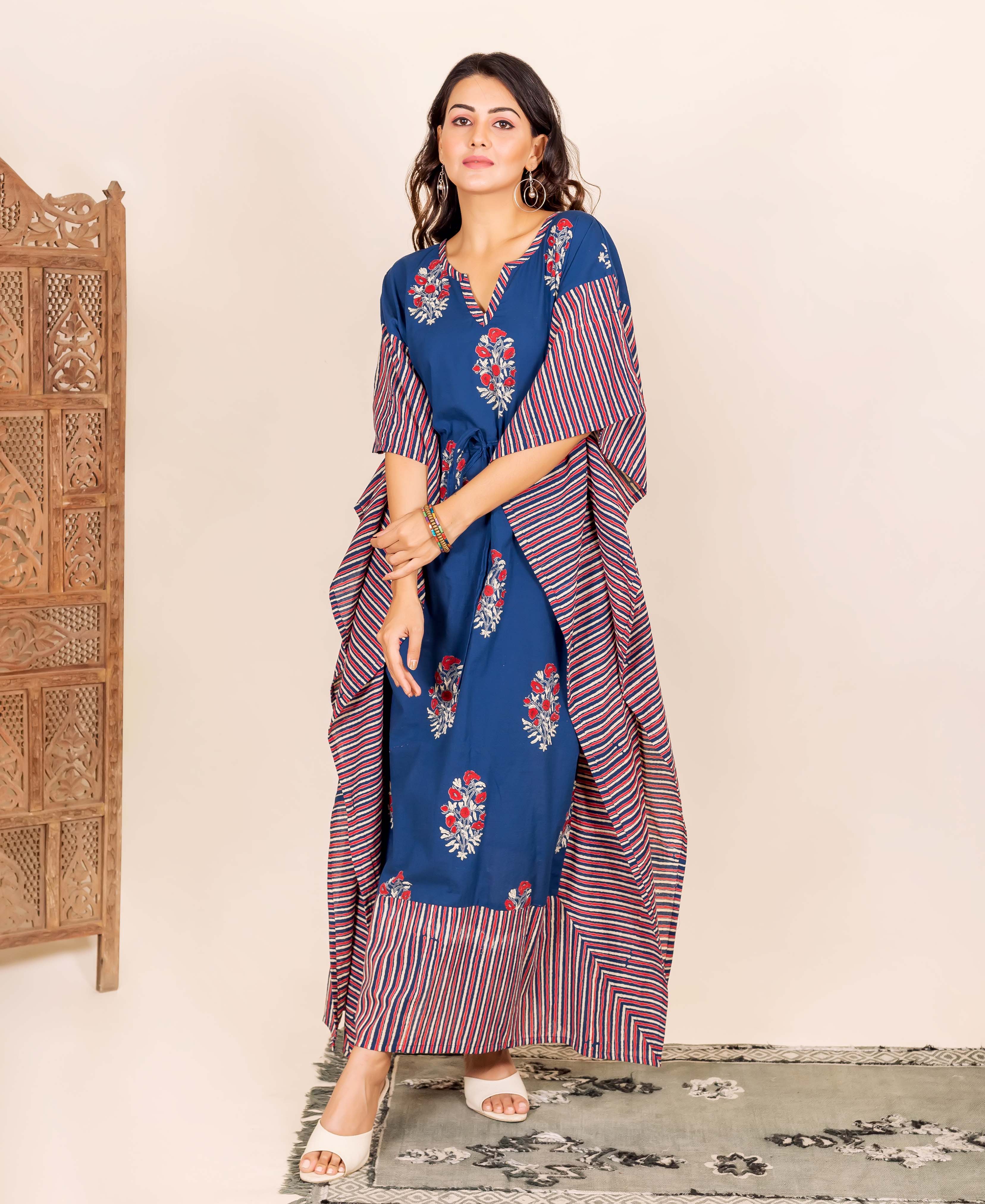 On a model, an indigo kaftan with red floral and striped prints and a tie-up waist.