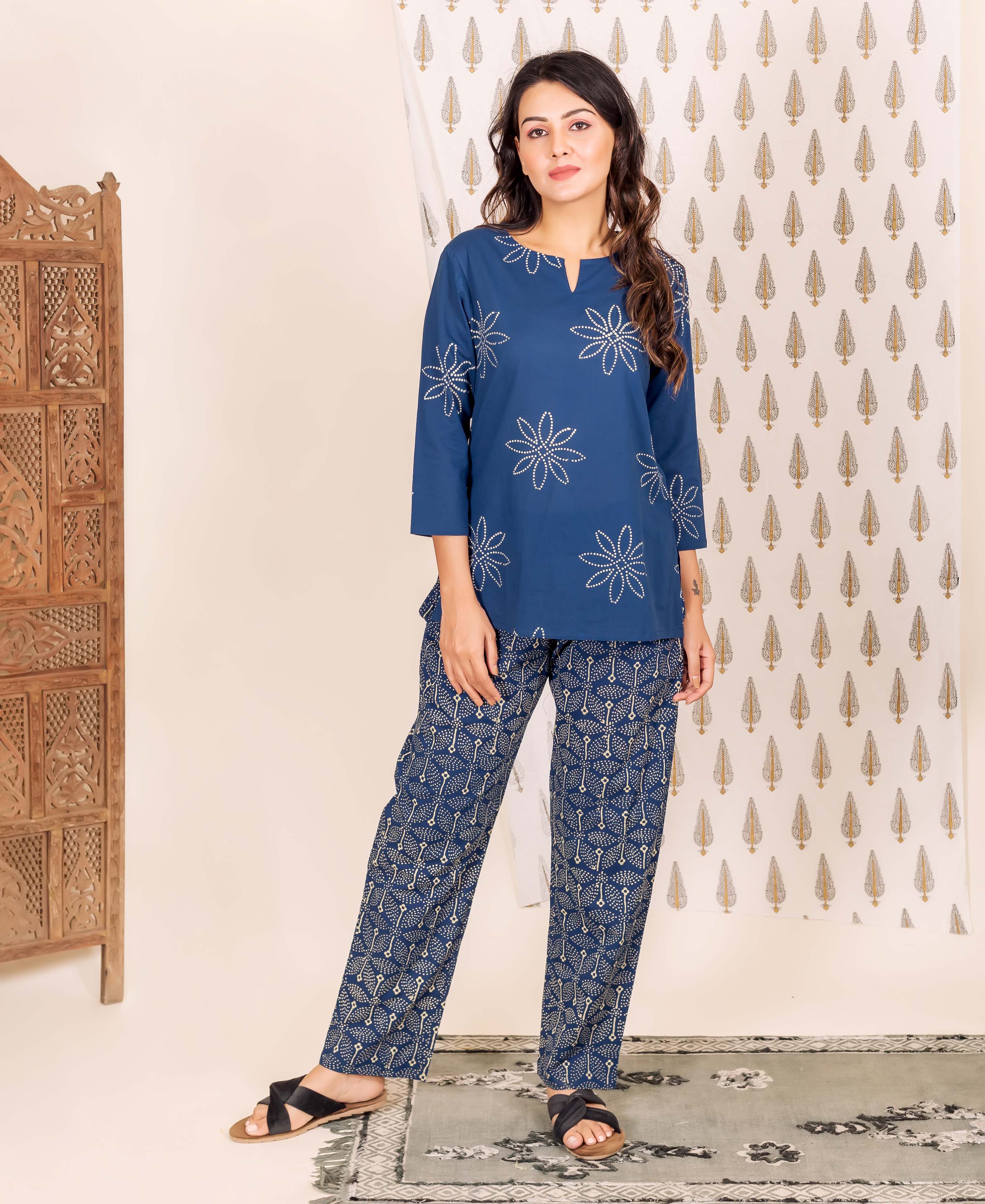 Woman in indigo blue hand block printed ethnic home wear with floral top and patterned pants.