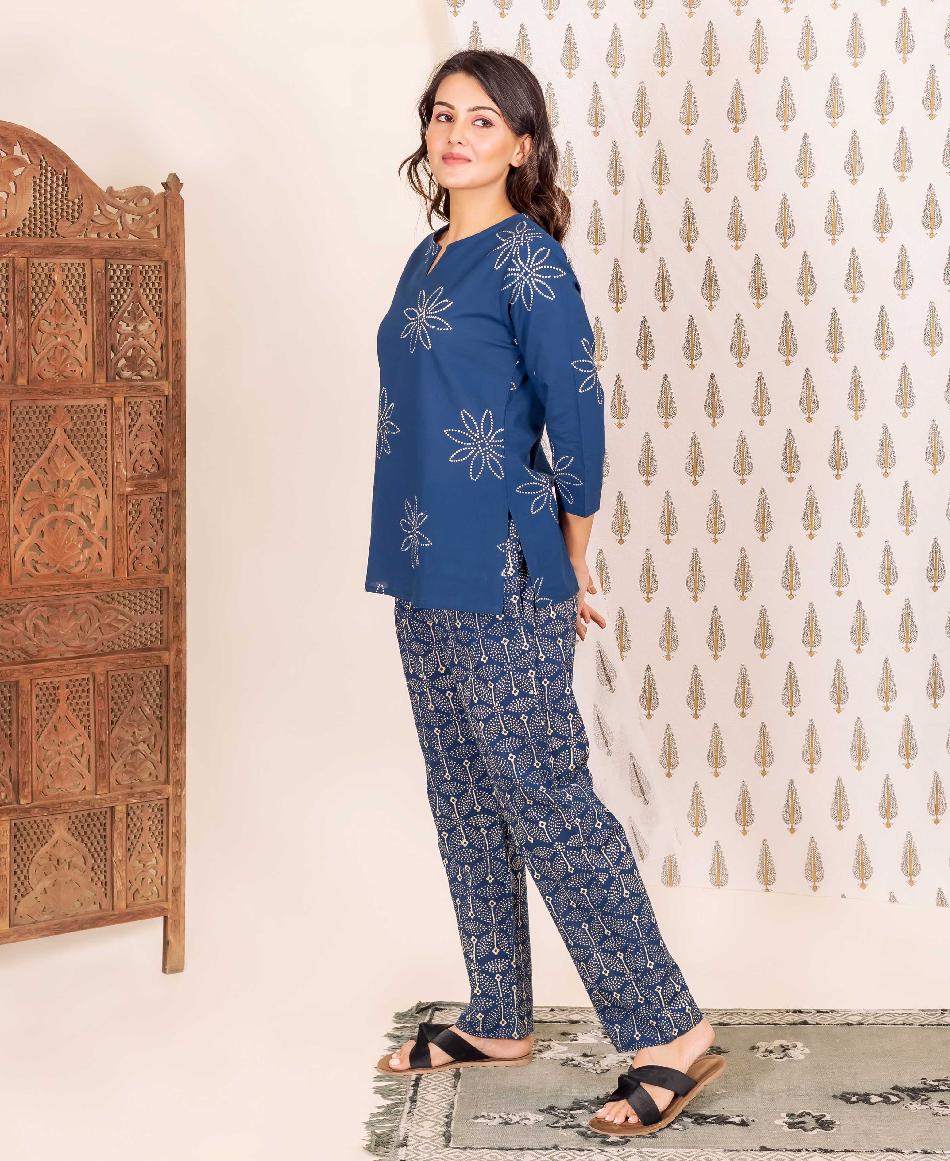 Side view of model wearing indigo blue hand block printed floral top and geometric patterned pants.