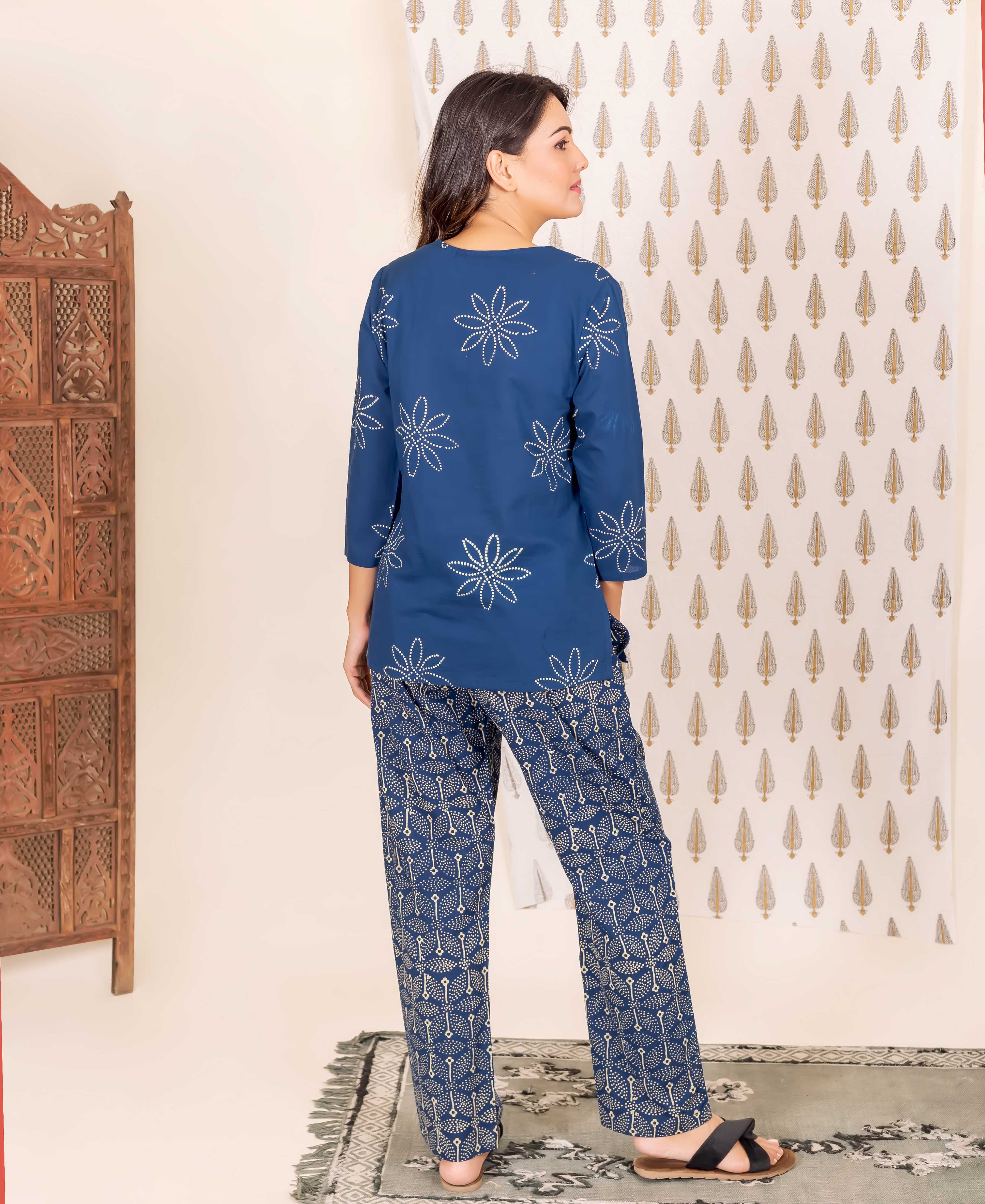 Back shot of model in indigo blue hand-block printed two-piece with floral and geometric designs.