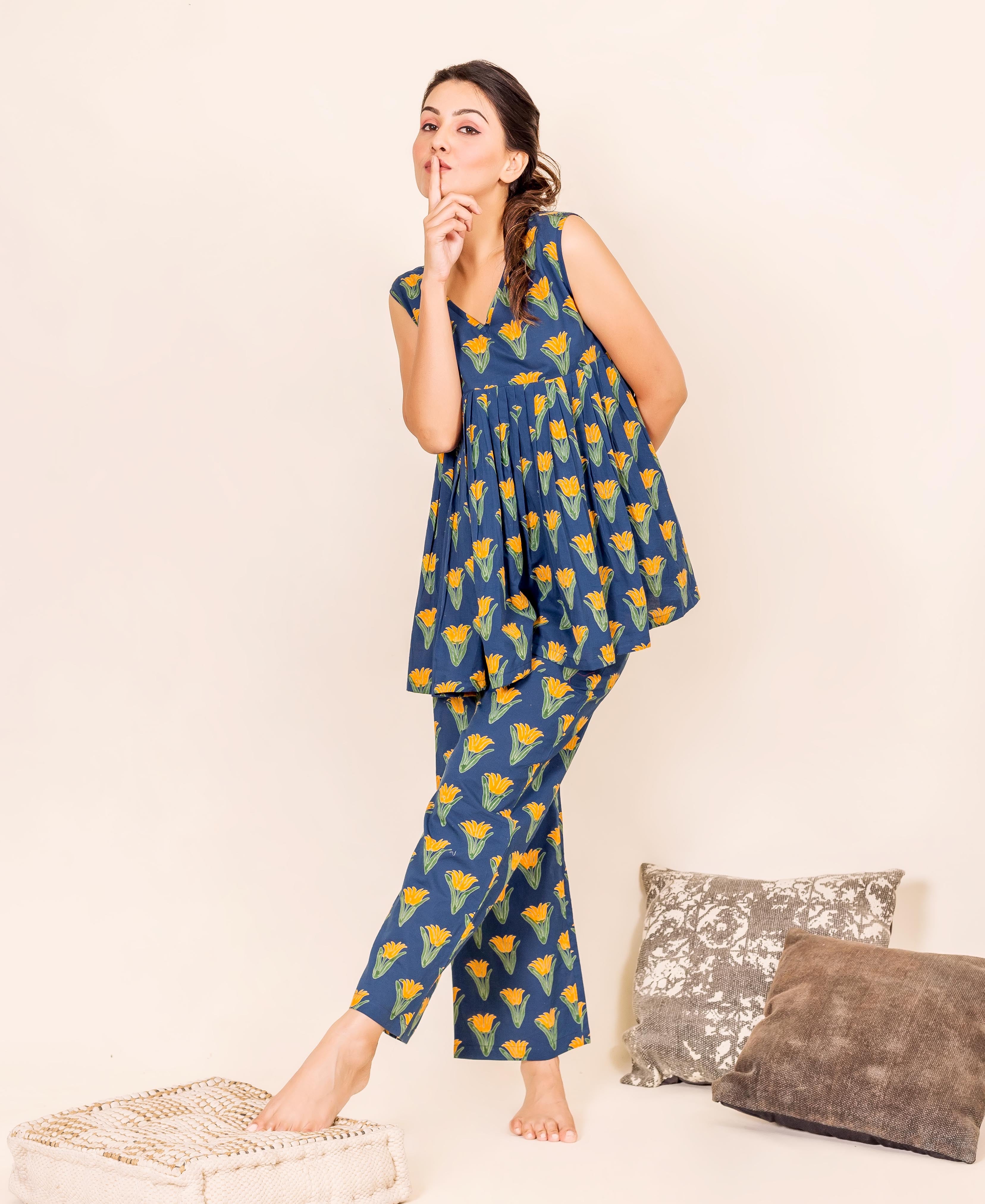 Full front model wearing indigo floral peplum top and pants home wear.