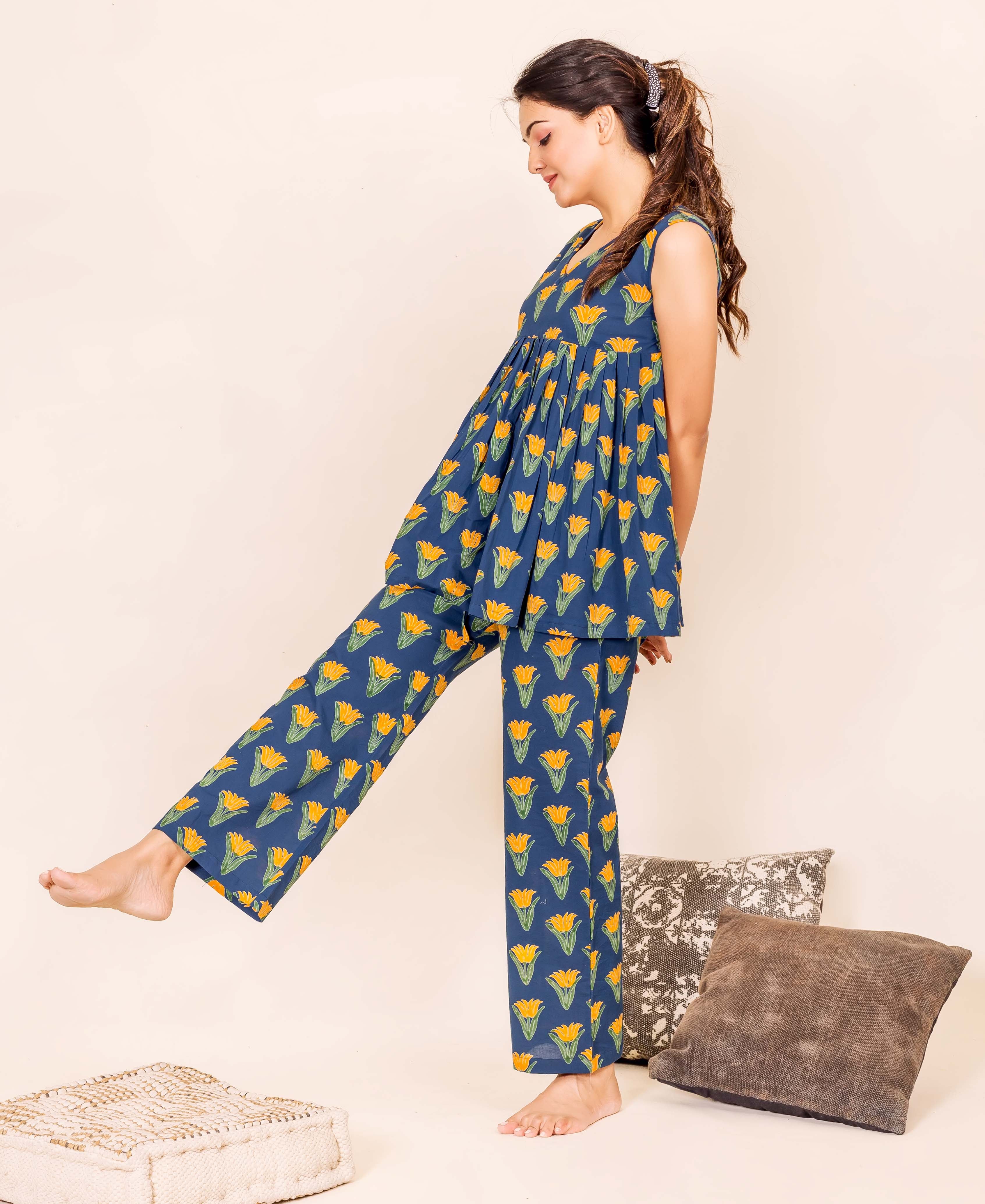 Model wears indigo blue peplum top and bottom home wear with yellow floral print.