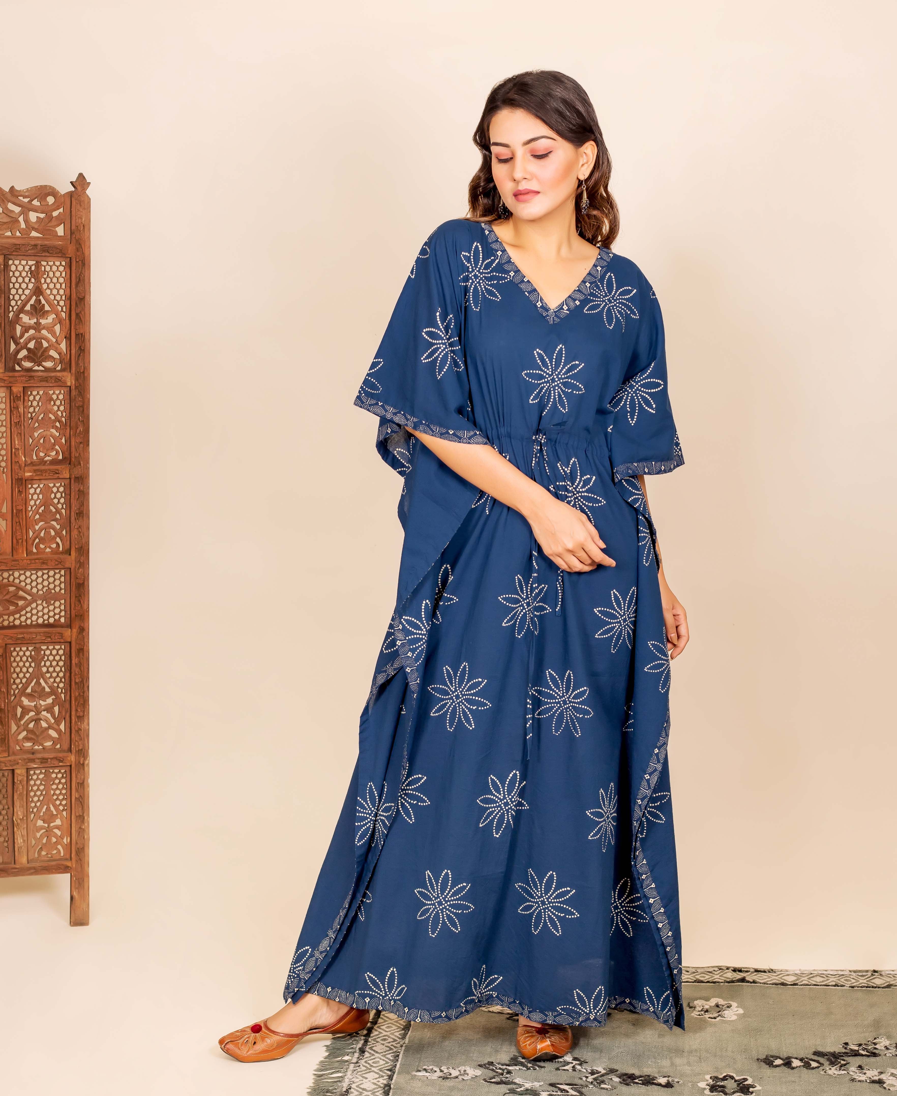 Model wears indigo blue hand block printed kaftan with white star patterns and drawstring waist.