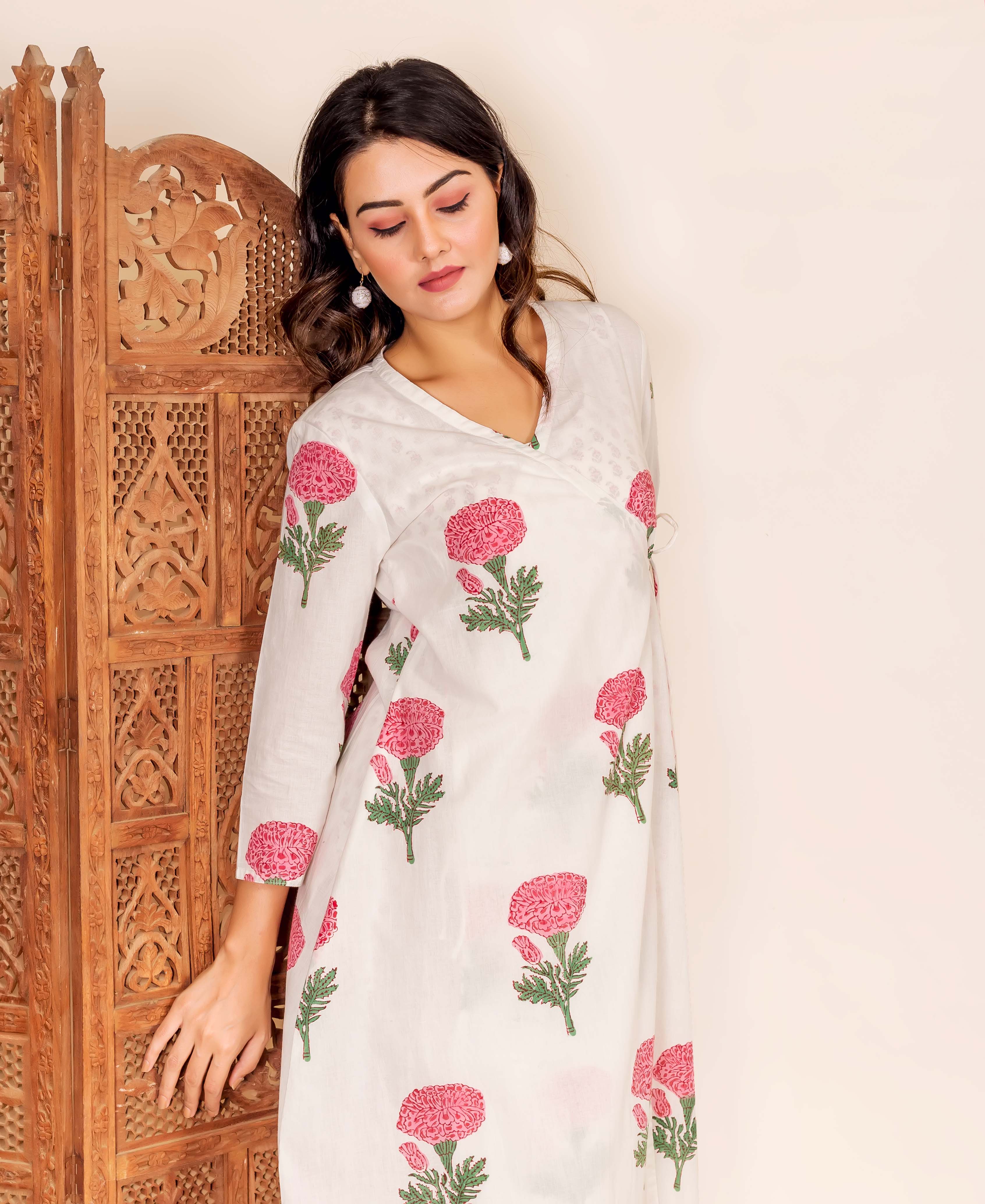 Model in white wrap-around tunic with pink marigold hand-block prints.