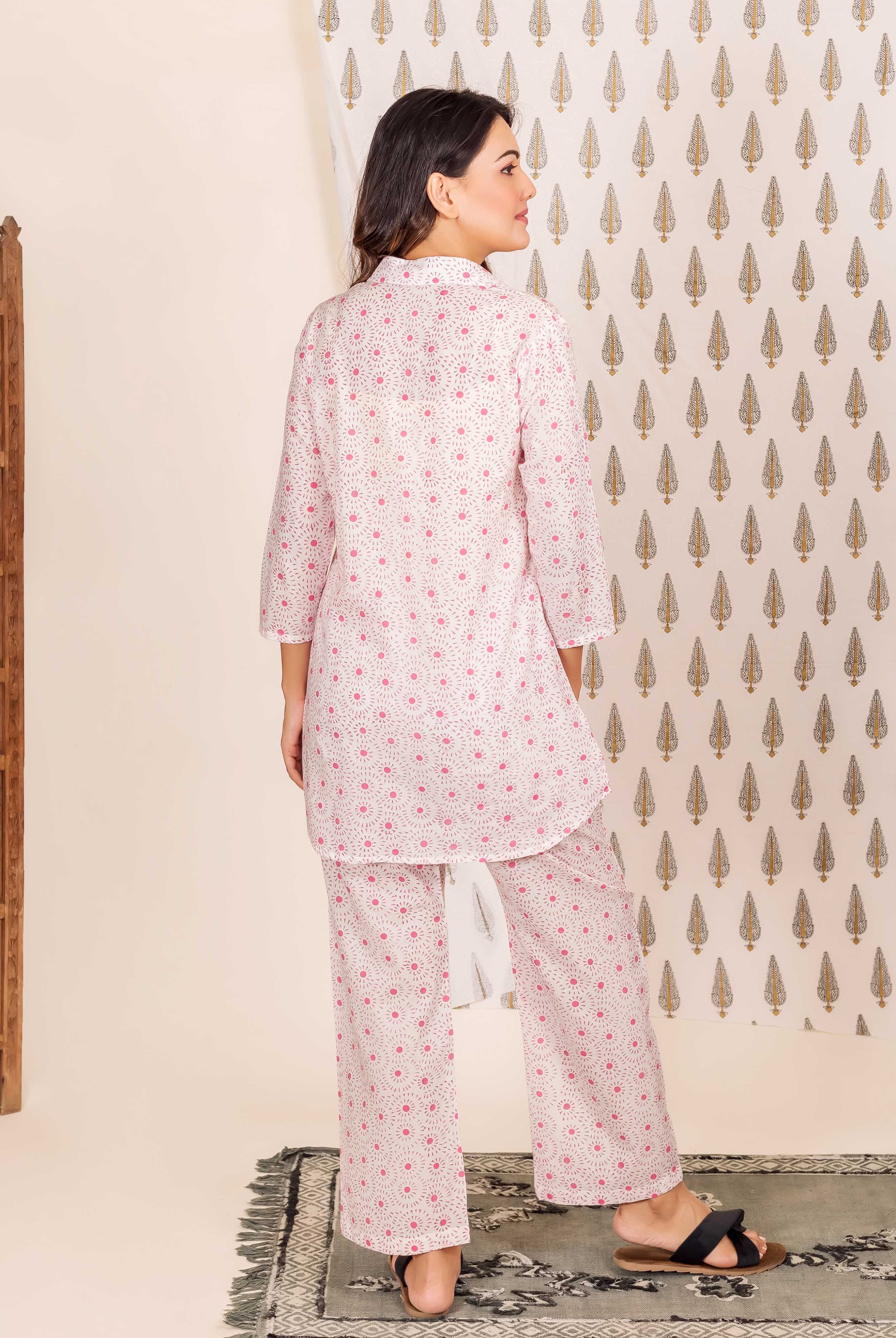 Back view of model in white and pink hand-block-printed ethnic shirt-style pajama set.
