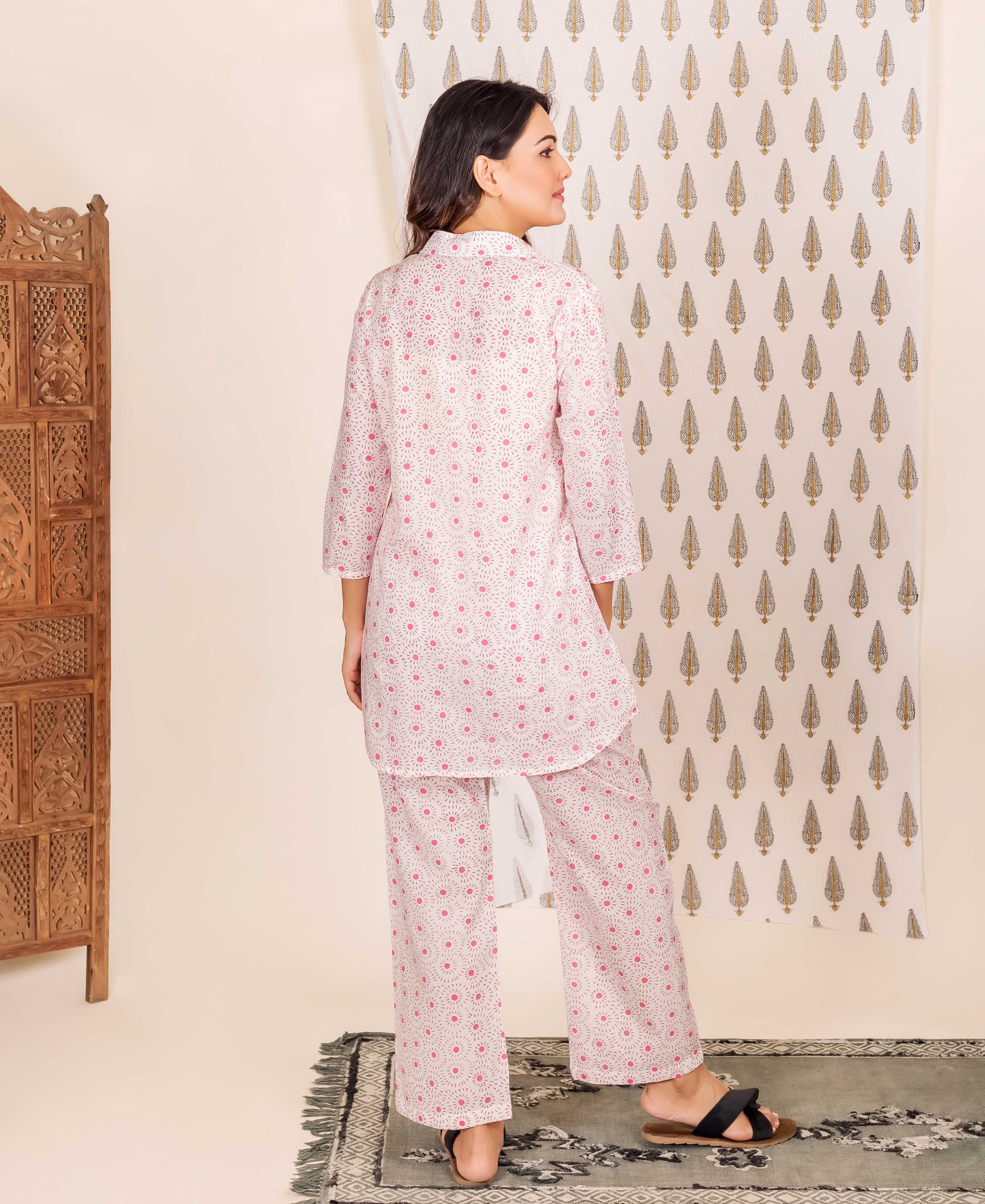 Back view of model in white and pink hand-block-printed ethnic shirt-style pajama set.