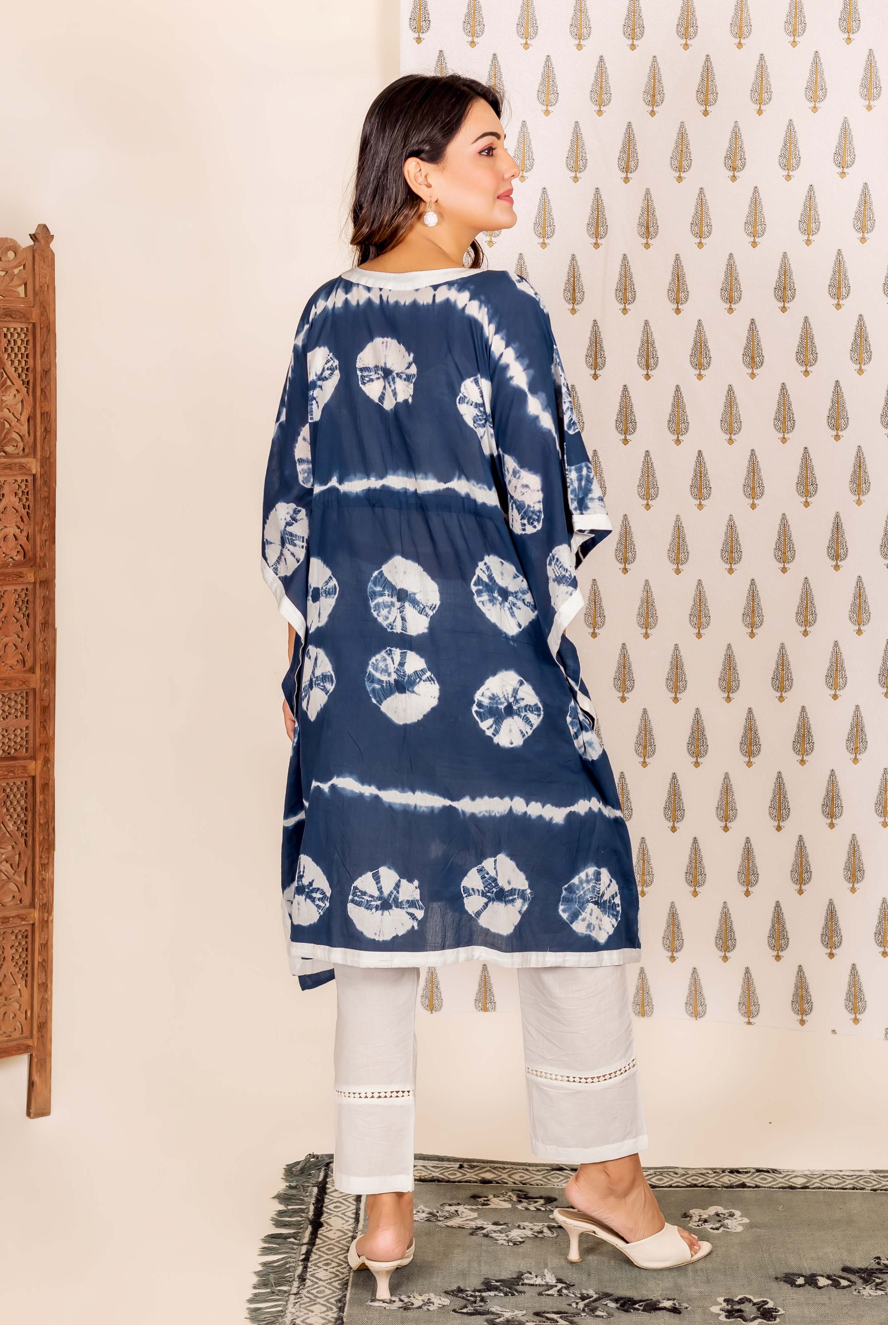 Model's back view, wearing a navy blue and white tie-dye kaftan set.