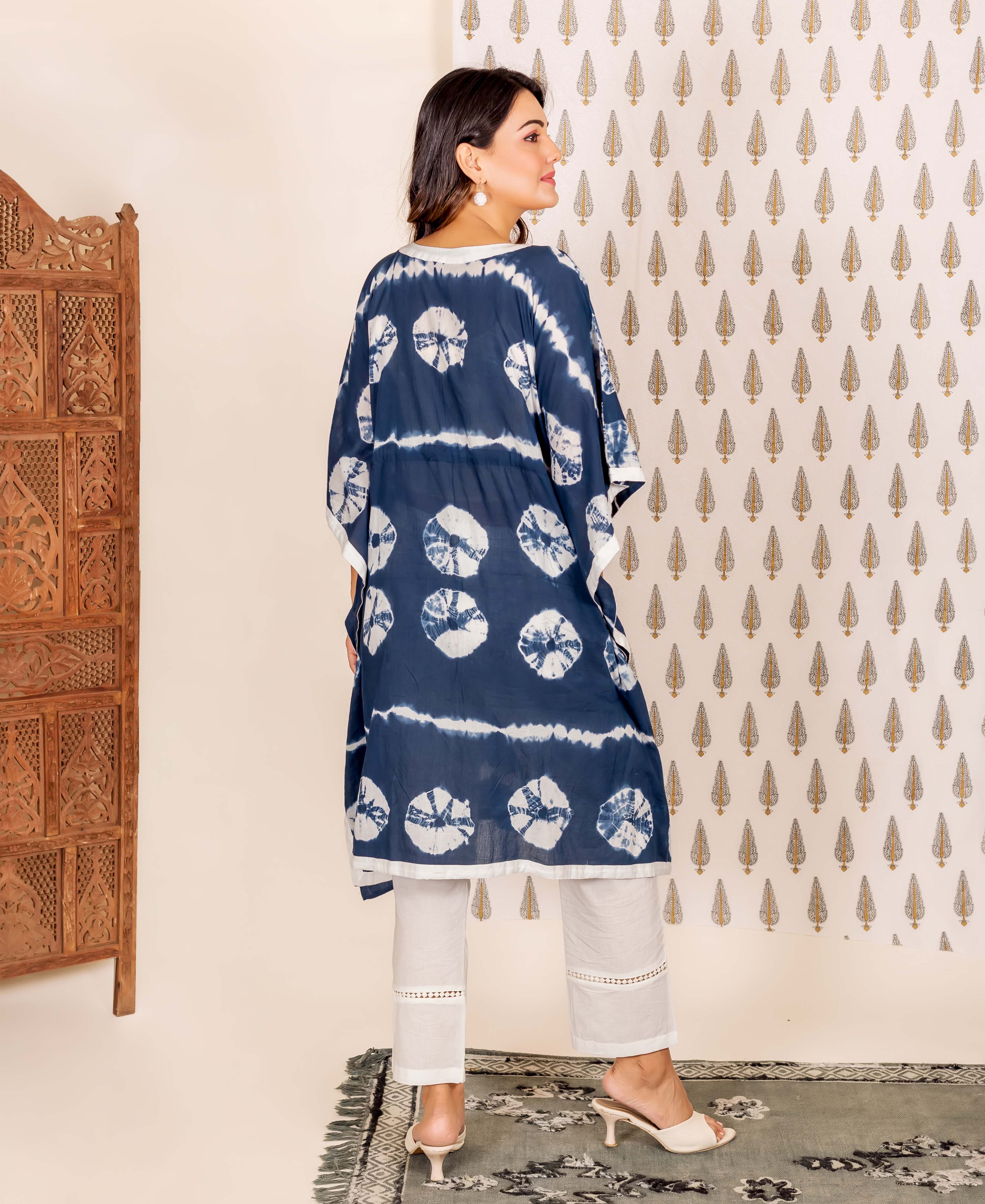 Model's back view, wearing a navy blue and white tie-dye kaftan set.