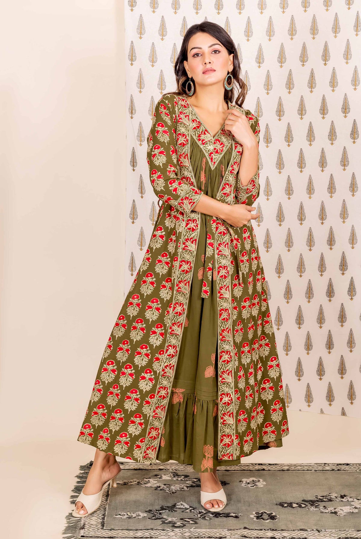 Model wearing olive green and red hand-block printed ethnic dress and long overlay.