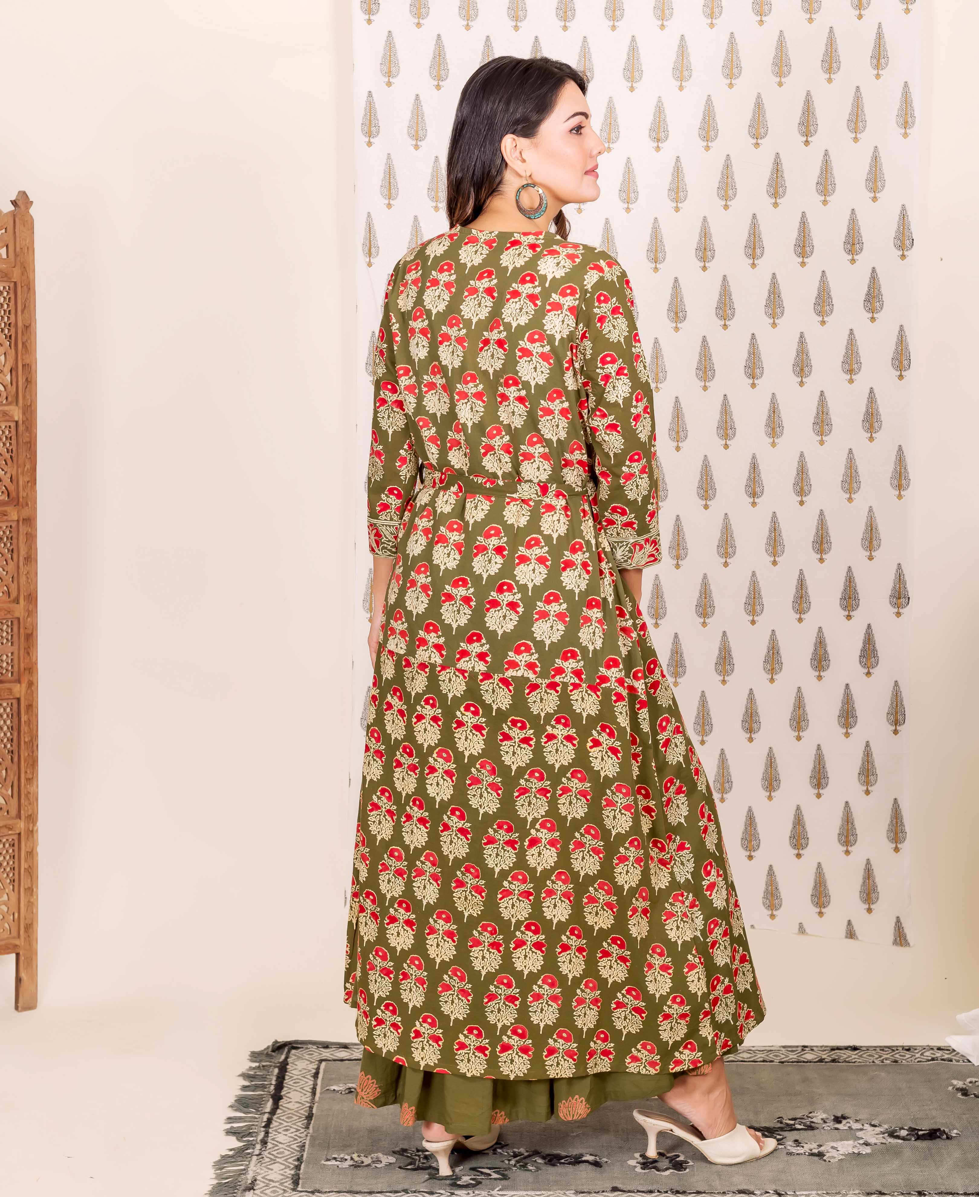 Back view of model in full-length olive green and red hand-block-printed nighty and overlay set.
