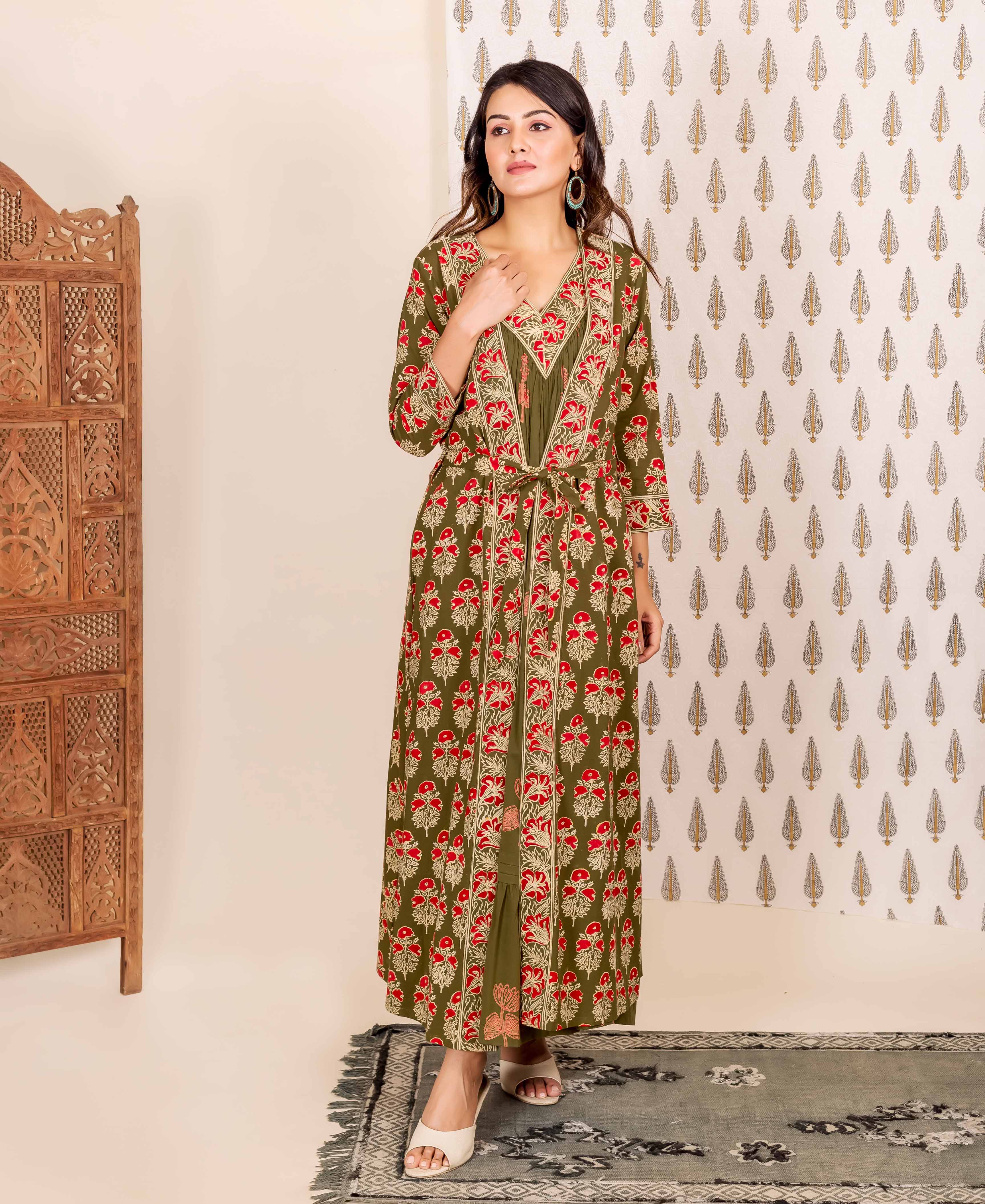 Woman wears olive green and red hand-block printed ethnic long dress with tied overlay.