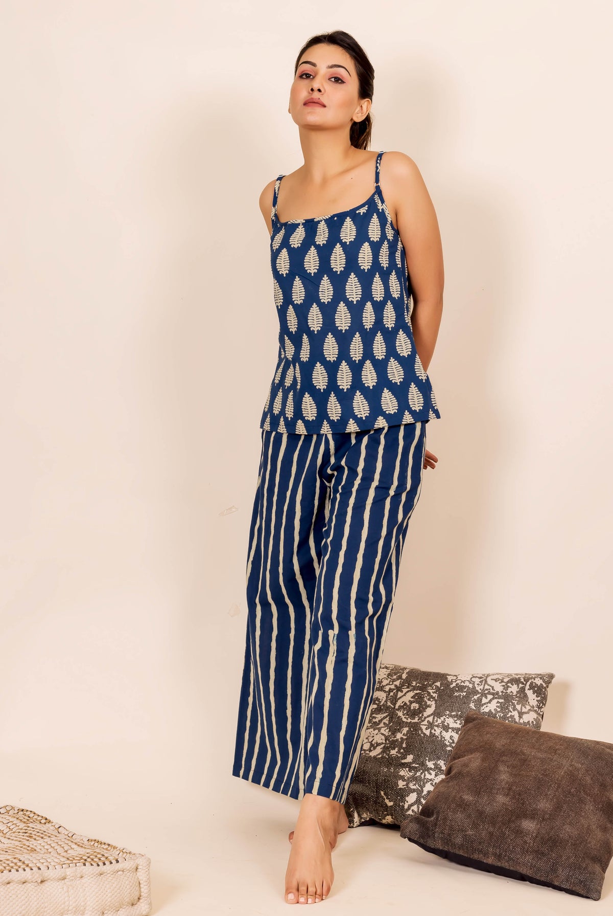 Full-length model in indigo blue leaf-print camisole and striped wide-leg pants.