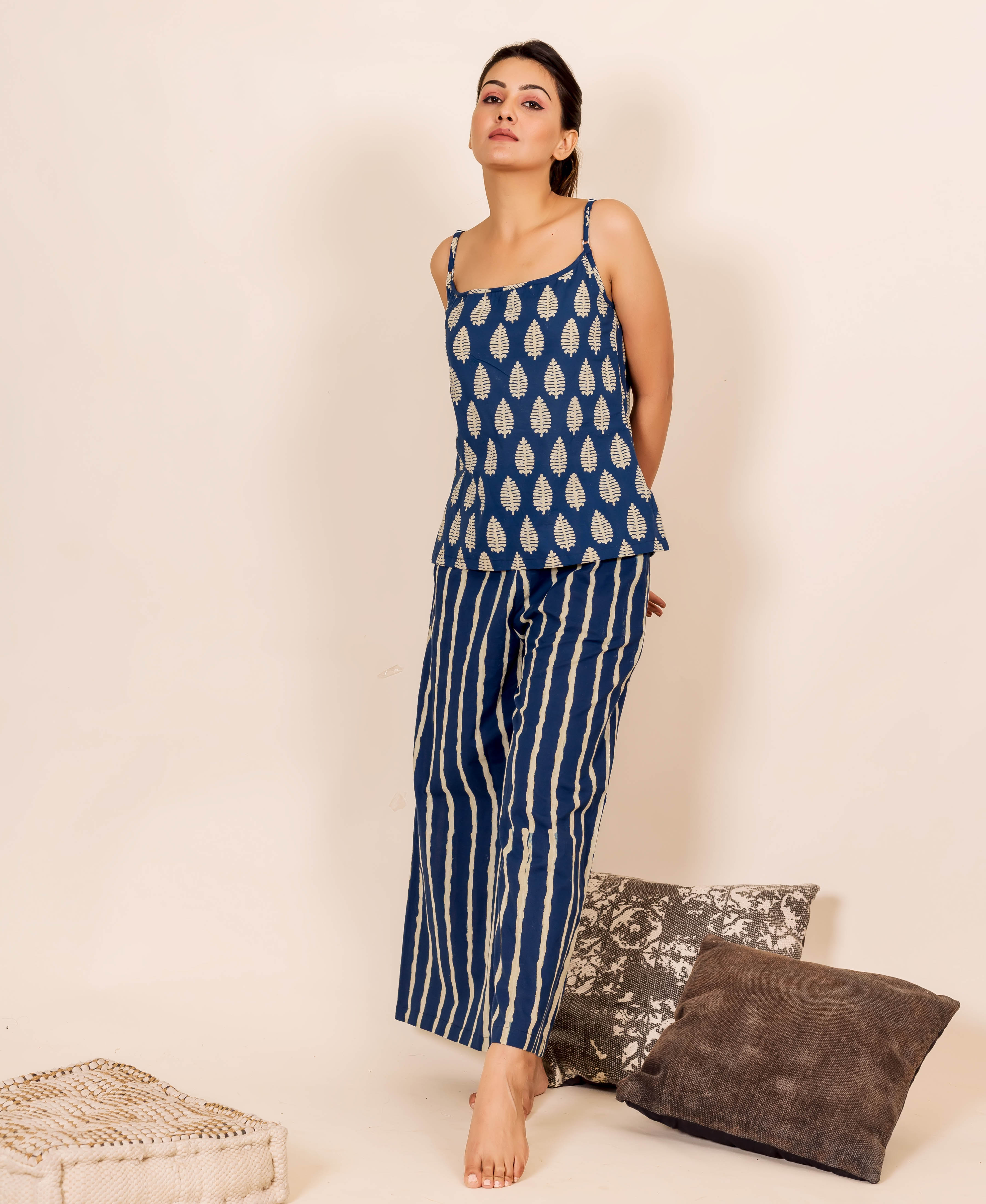 Full-length model in indigo blue leaf-print camisole and striped wide-leg pants.