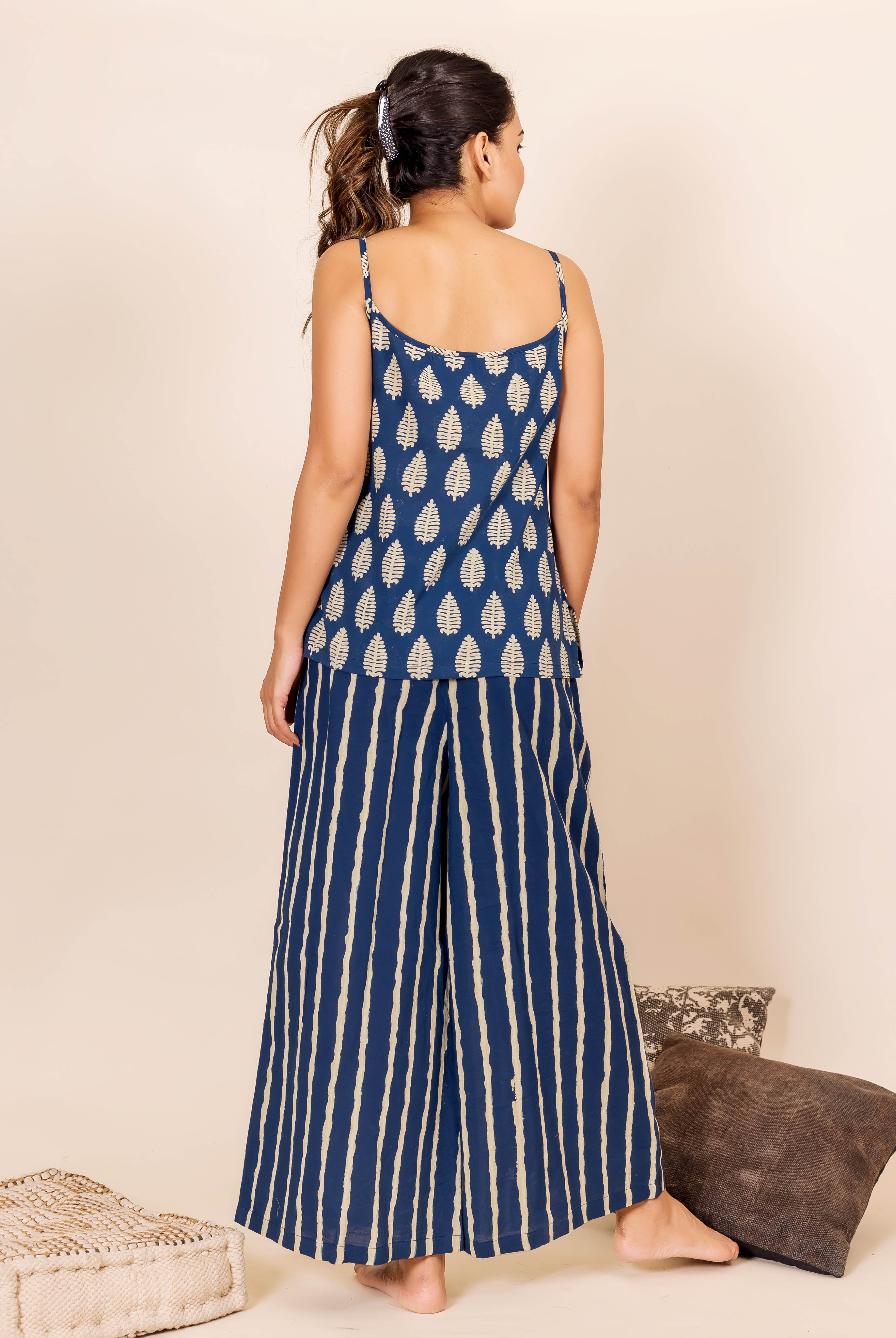 Back view of model wearing indigo block-printed leaf camisole and striped palazzo pants set.