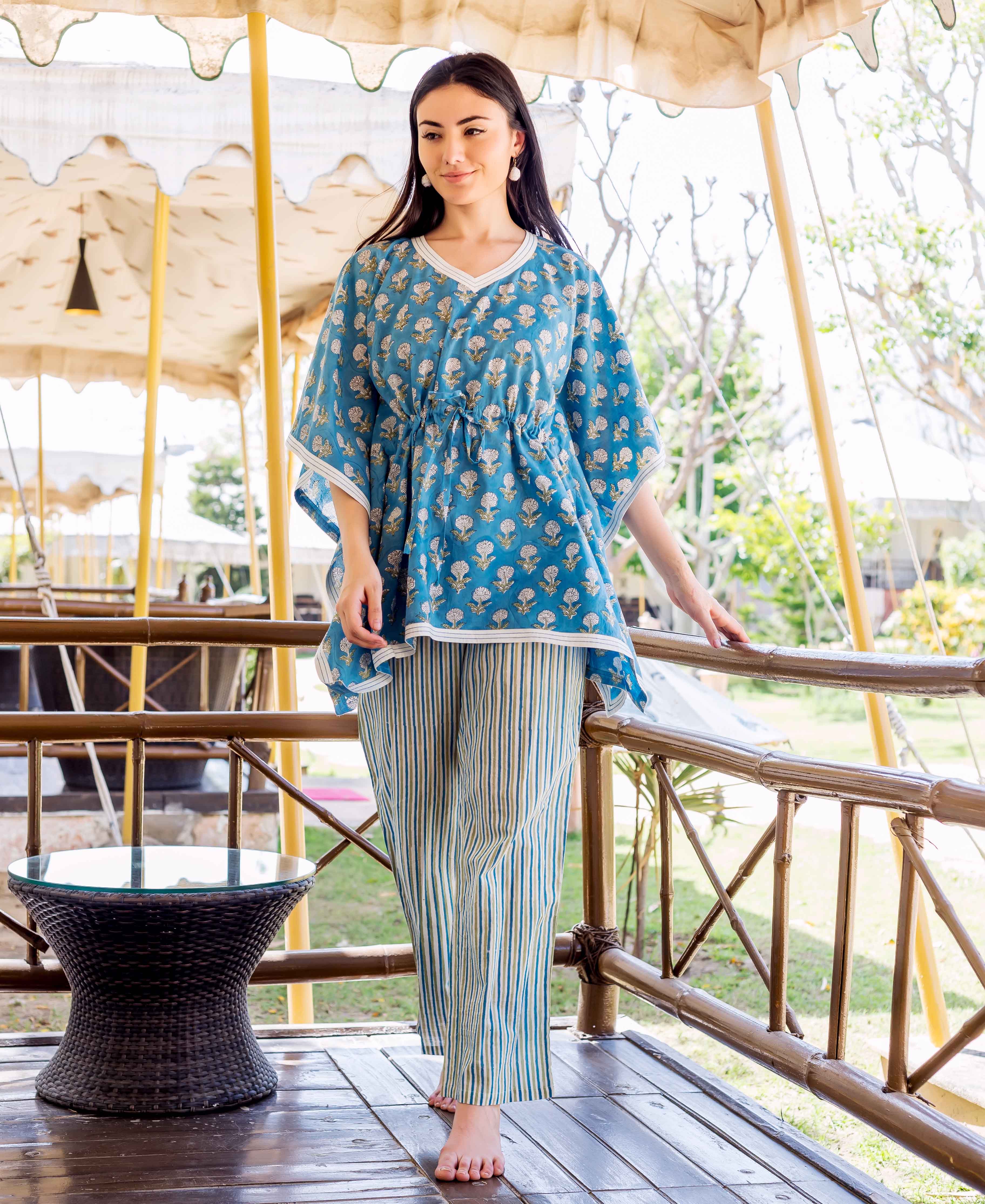 Model wearing blue hand-block printed floral kaftan top with striped trousers.