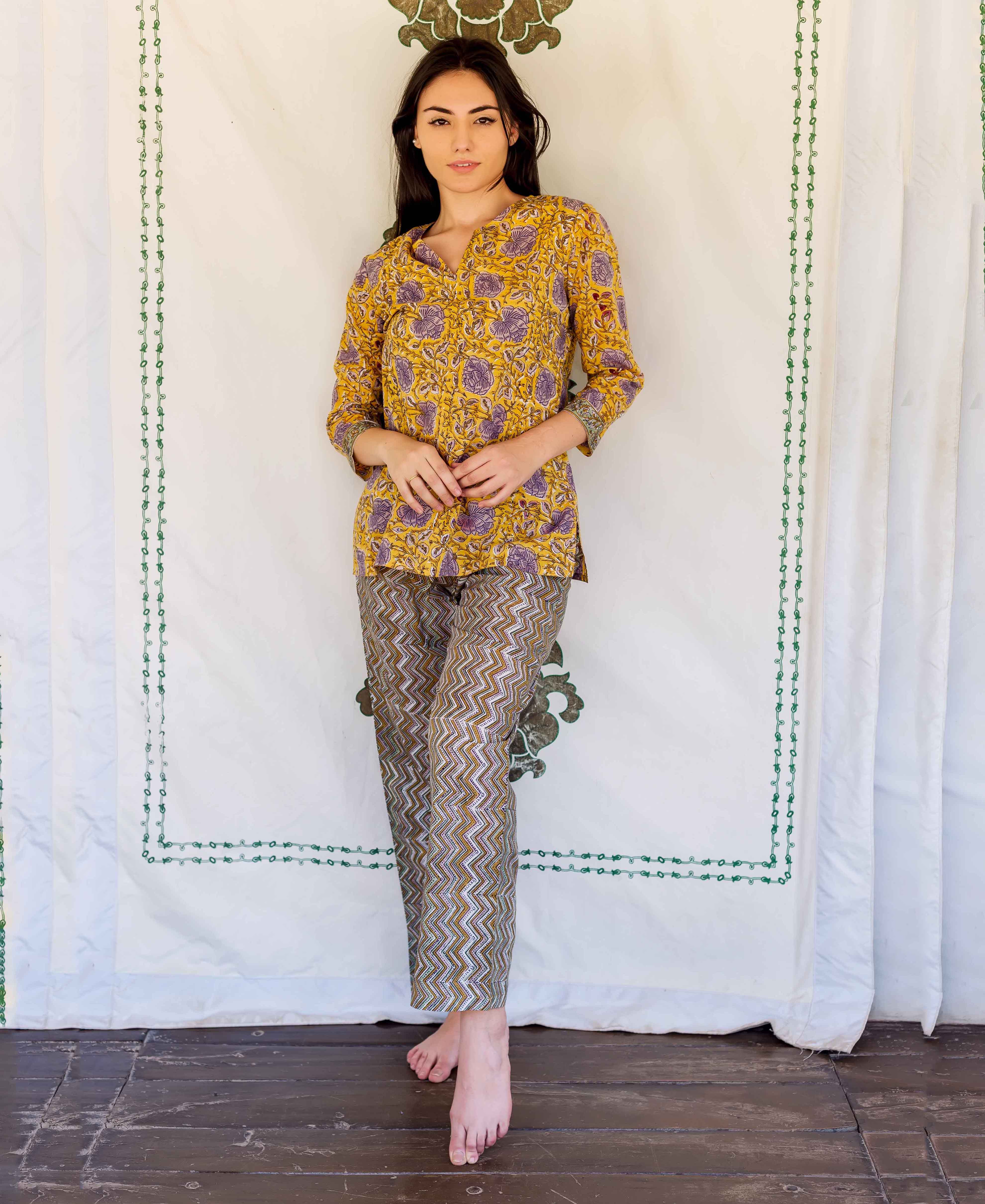 Model wears yellow, purple floral hand-block printed top and brown zigzag lounge pants.