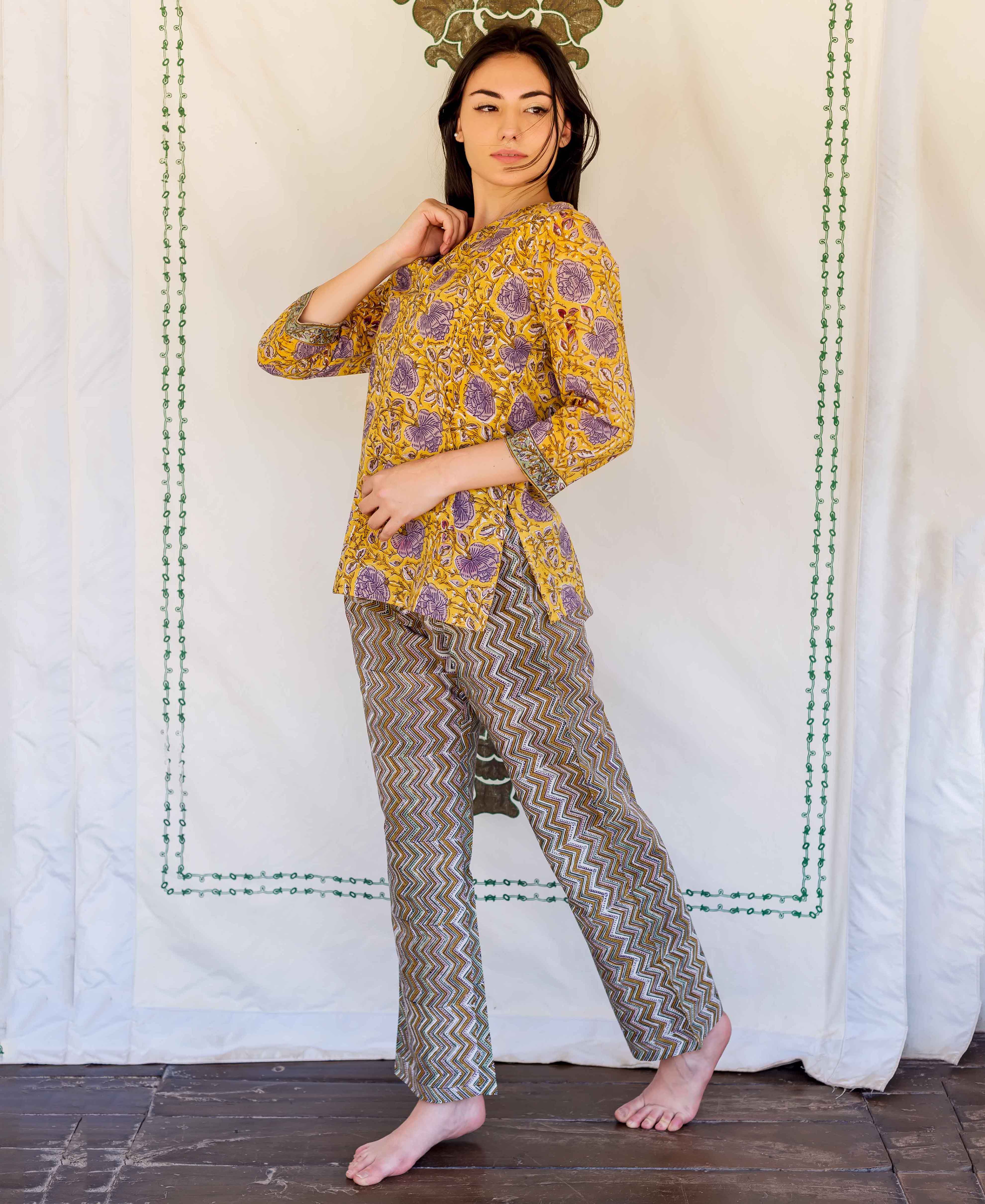 Standing model in yellow hand block printed floral top and olive zig-zag lounge pants.