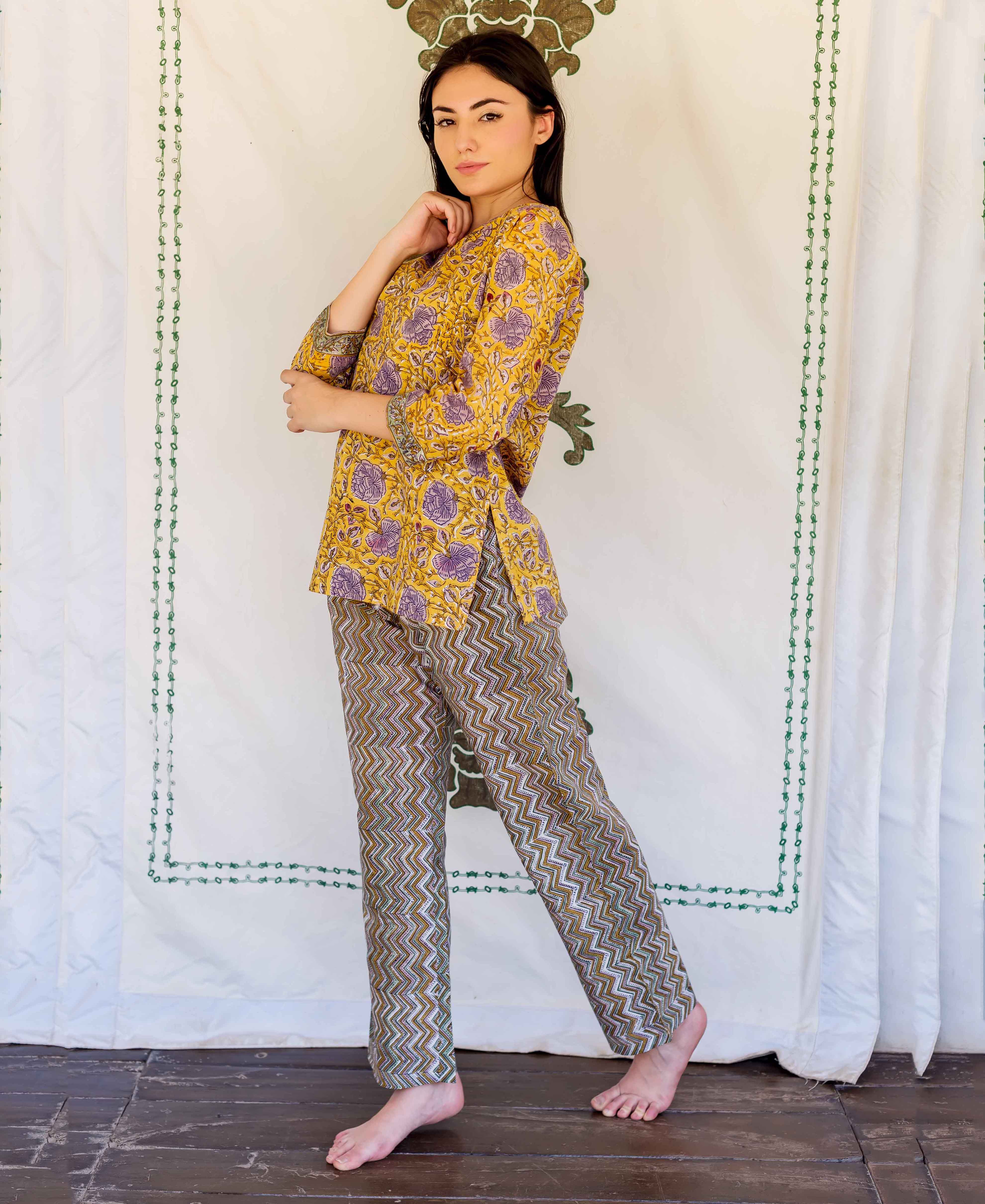Model wears yellow and purple floral hand block printed top with zigzag lounge pants.