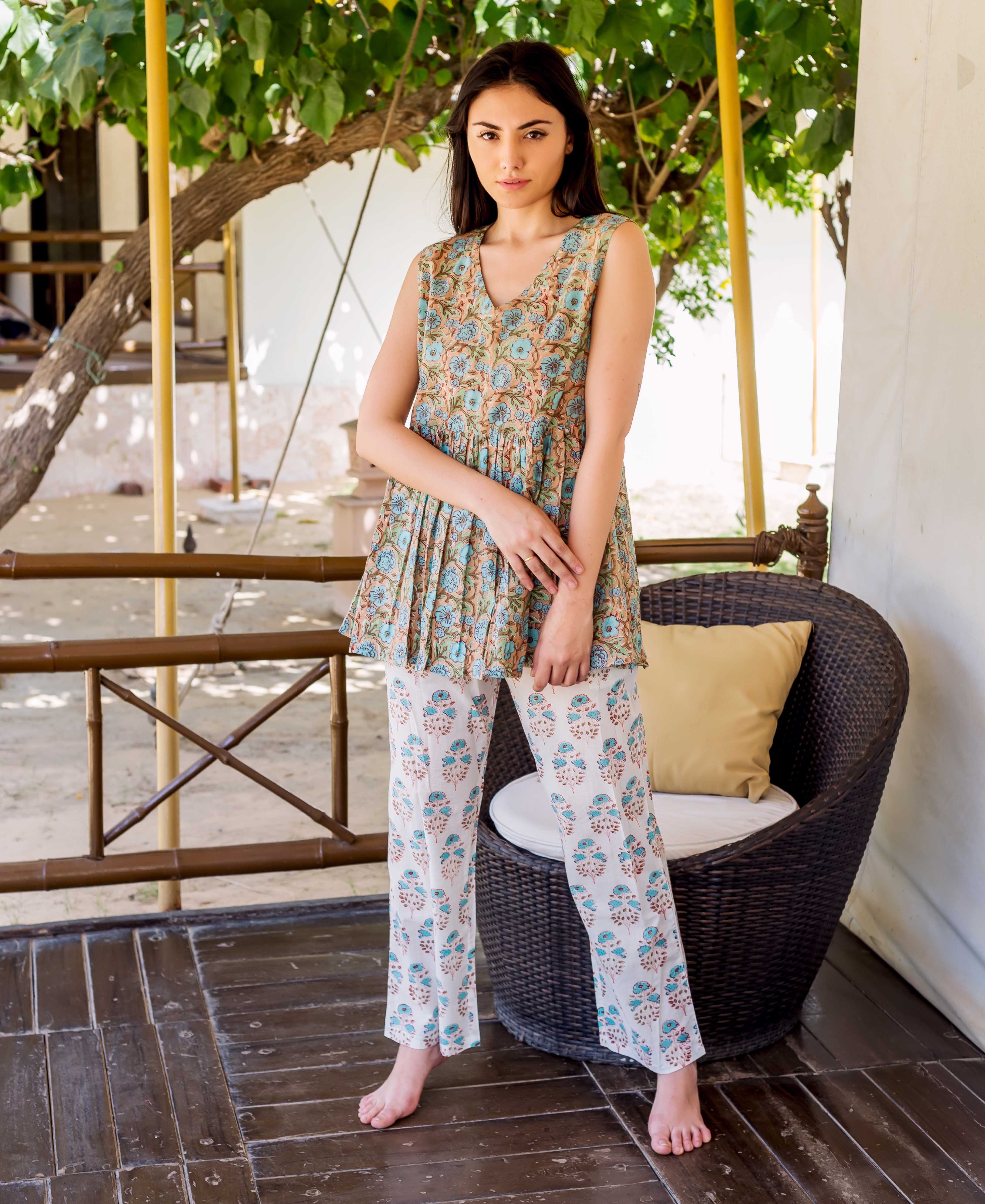 Full-body model in light brown peplum top and white hand-block printed floral pants.