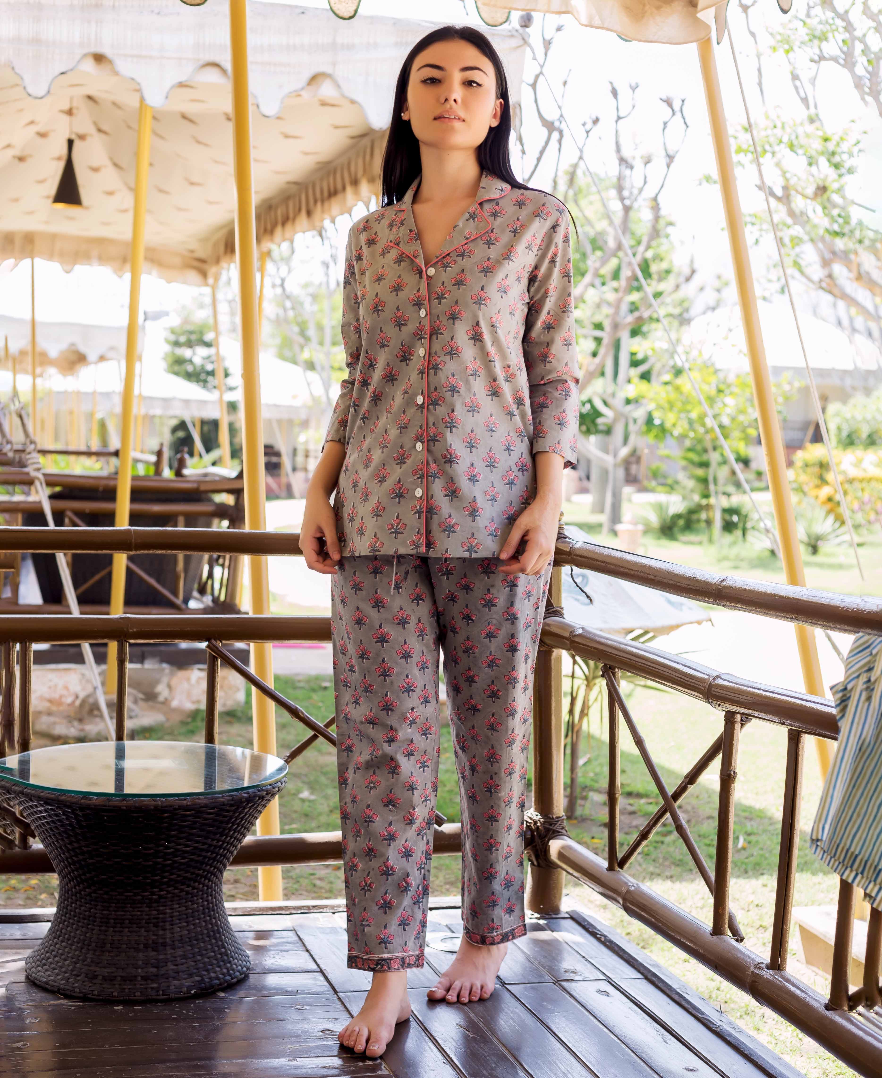 Model standing in grey hand-block printed night suit with pink floral ethnic pattern.