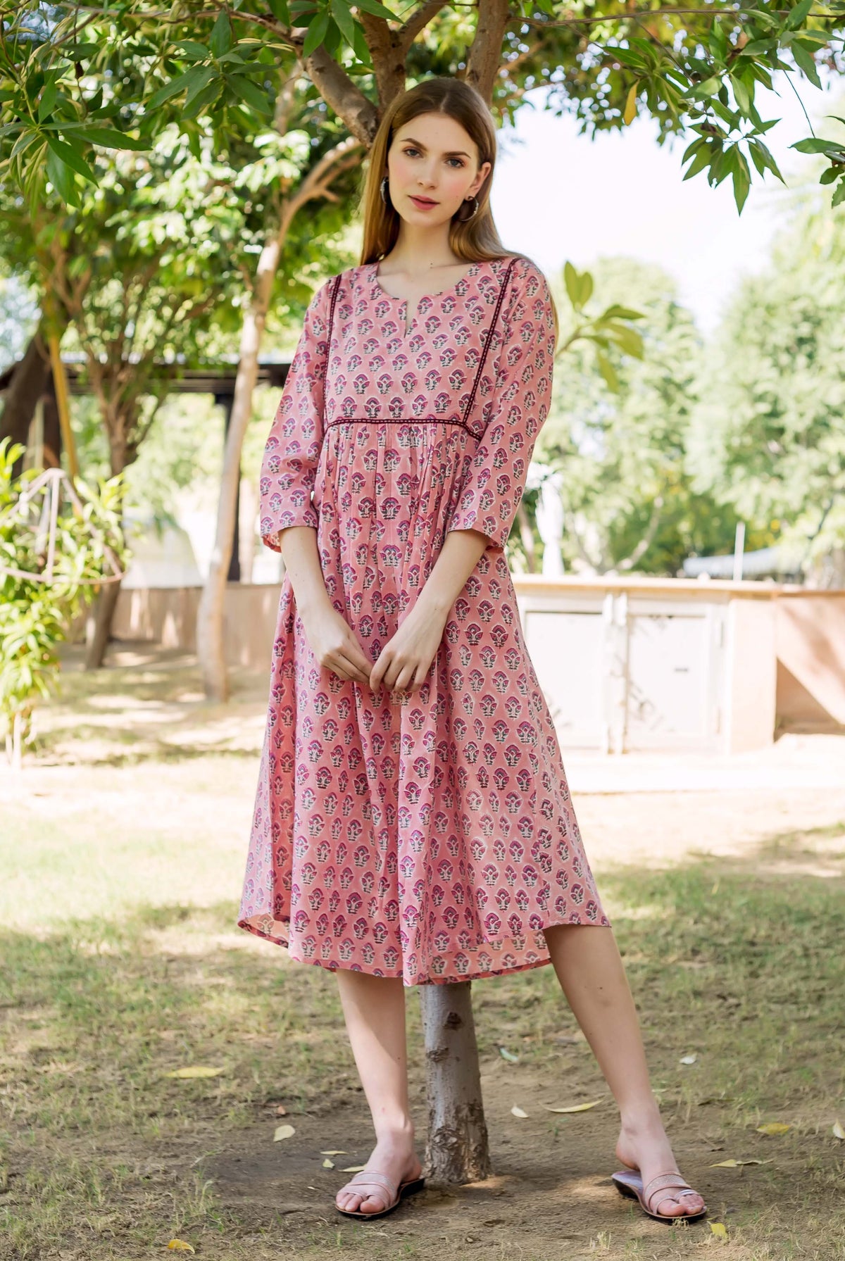 Full shot of a model wearing a peach hand block printed ethnic maternal nursing dress.