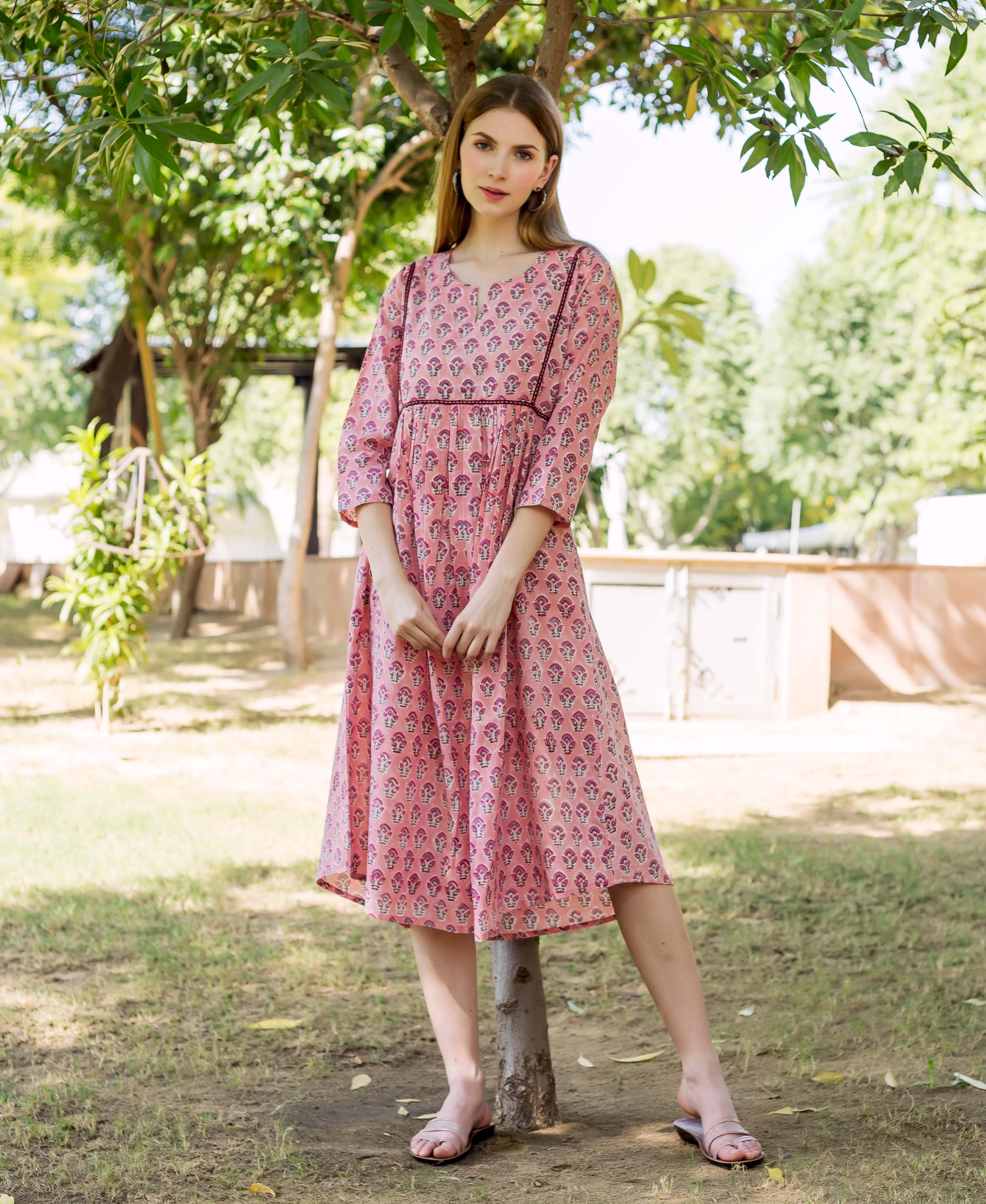 Full shot of a model wearing a peach hand block printed ethnic maternal nursing dress.