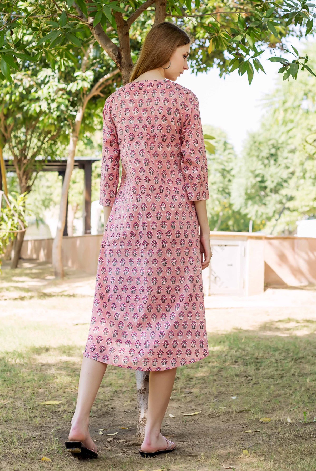 Peach hand block printed maternal and nursing dress on a model, rear view.