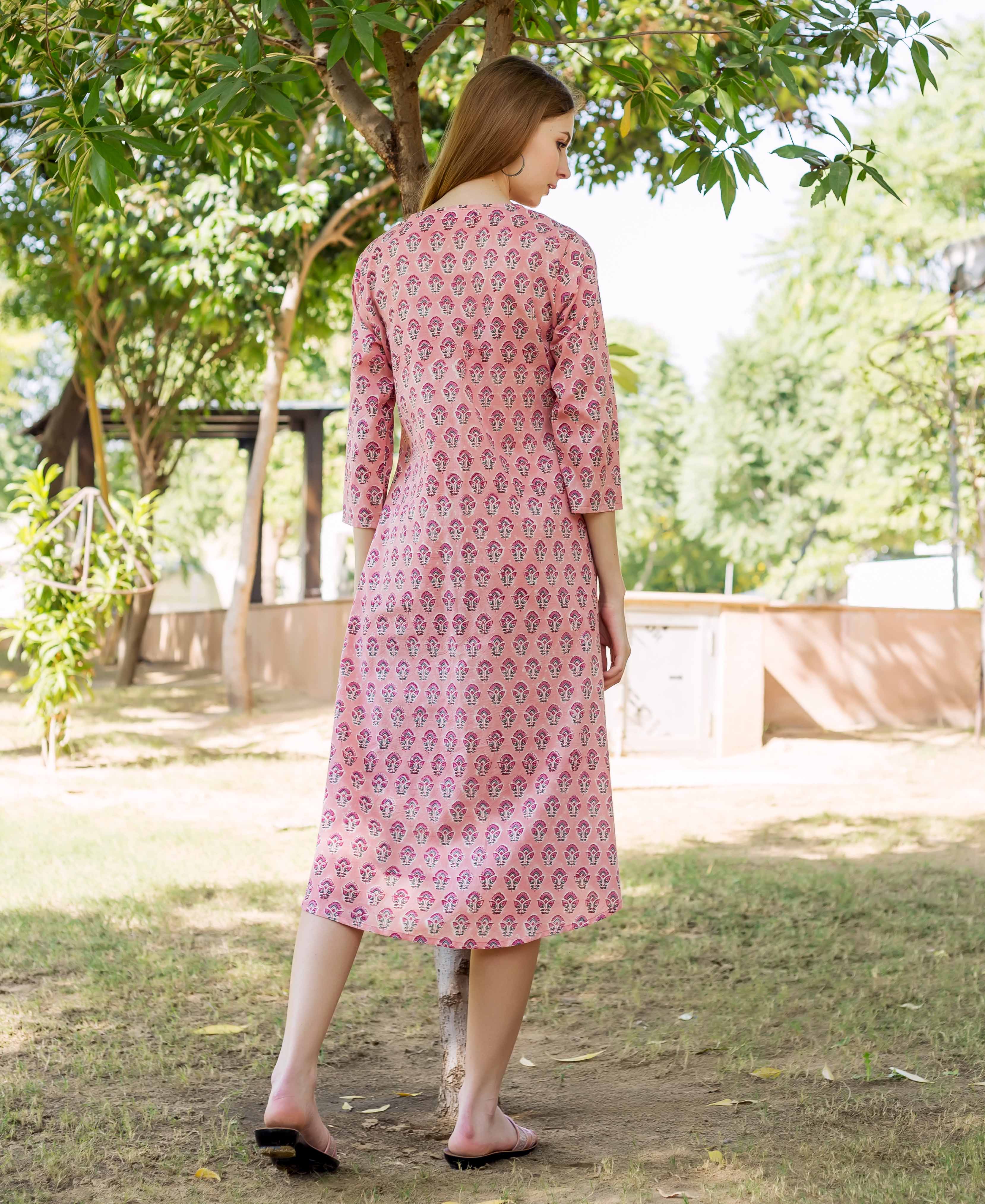 Peach hand block printed maternal and nursing dress on a model, rear view.