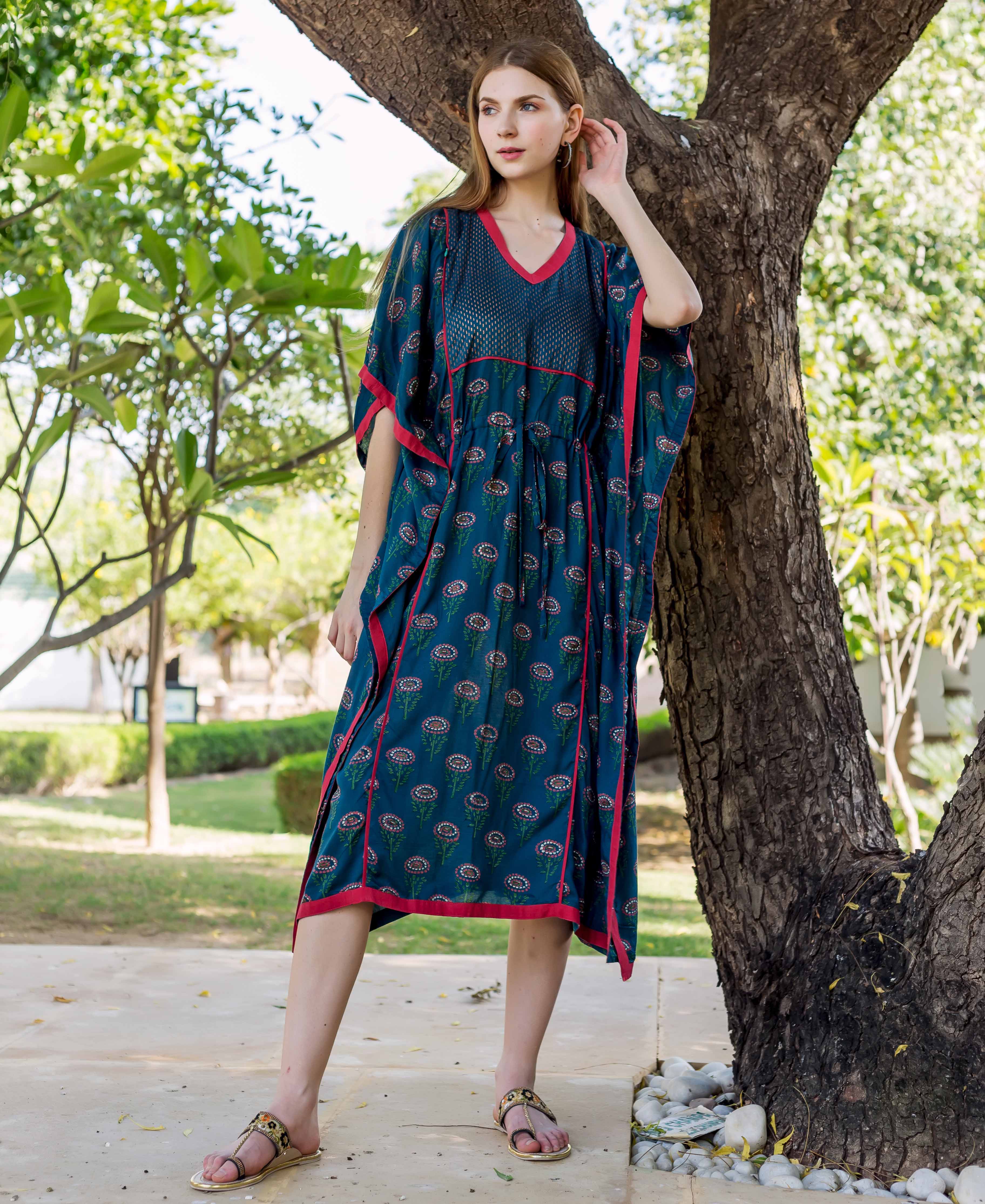Full-length model wears peacock green hand-block-printed ethnic maternal and nursing kaftan with red trim.