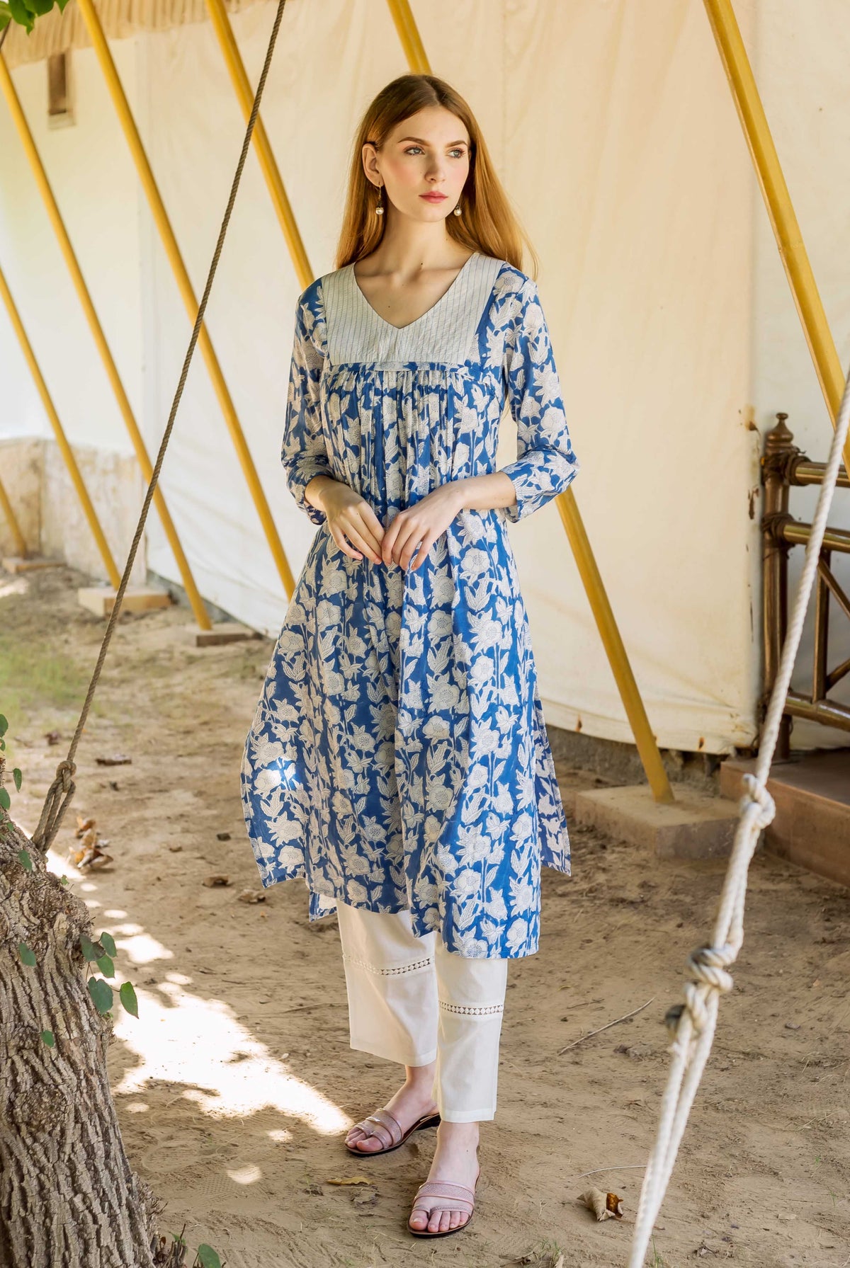 A model wearing a blue and white floral print kurta.
