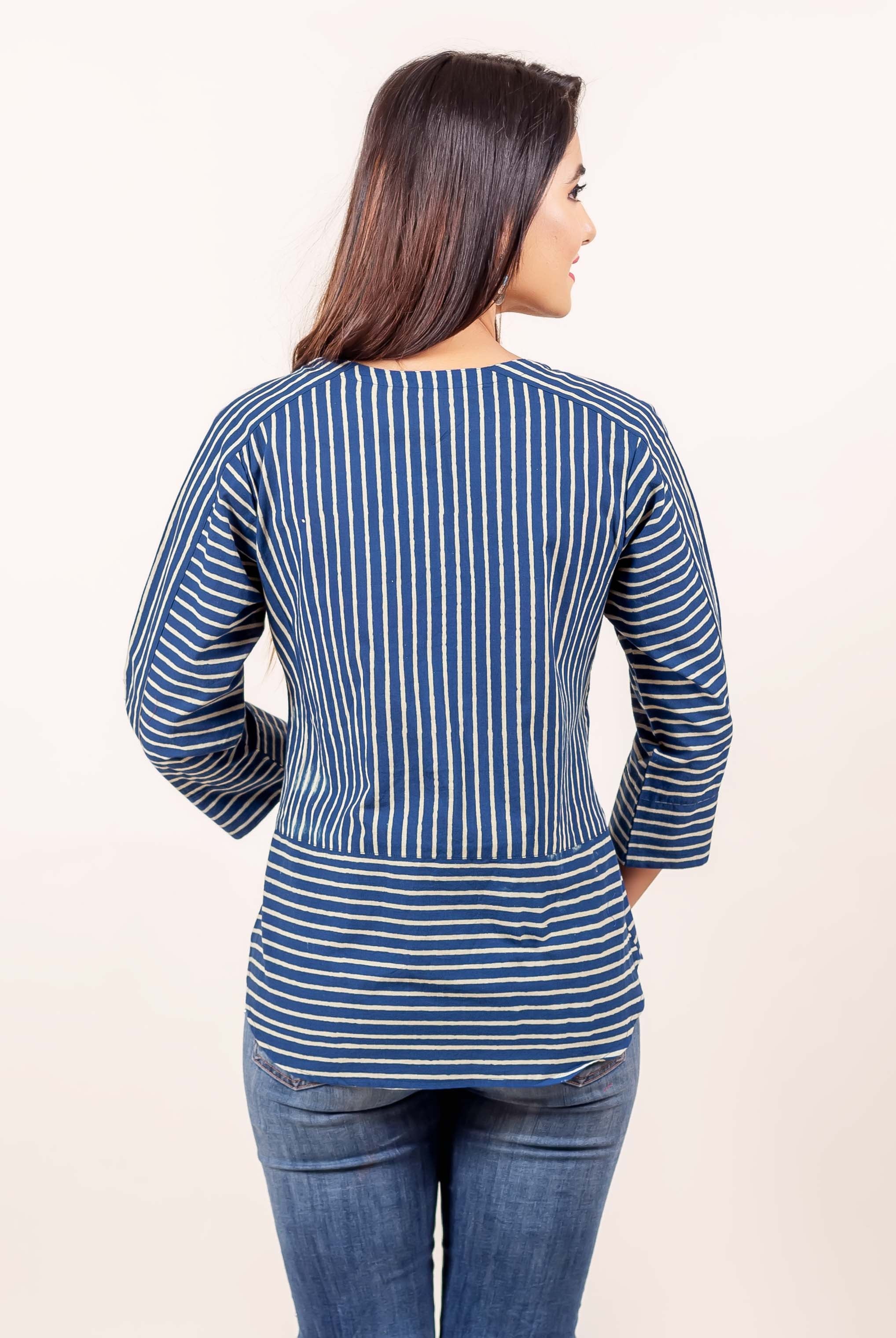 Back view of model in indigo blue hand block printed top with mixed vertical and horizontal stripes.