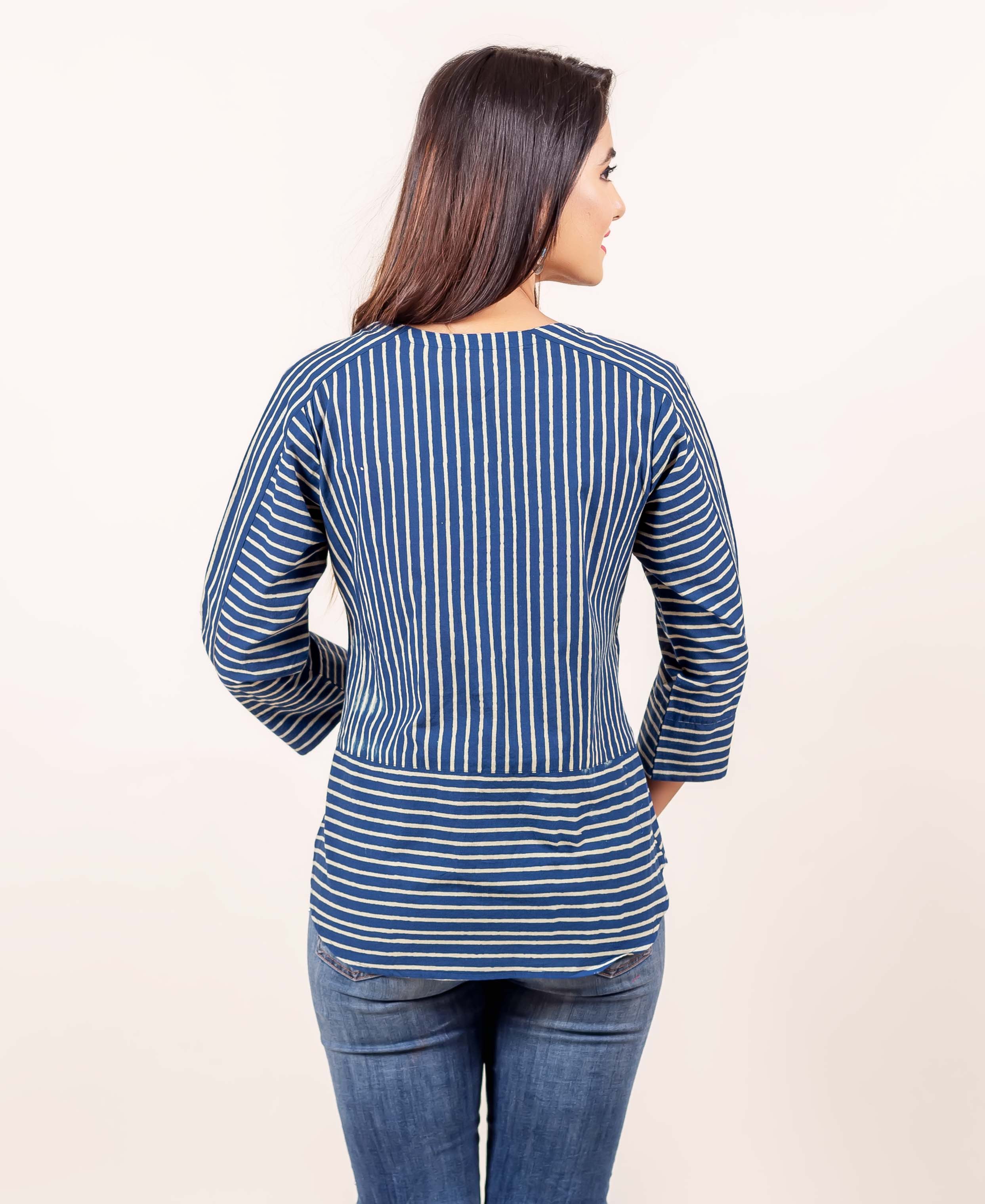Back view of model in indigo blue hand block printed top with mixed vertical and horizontal stripes.