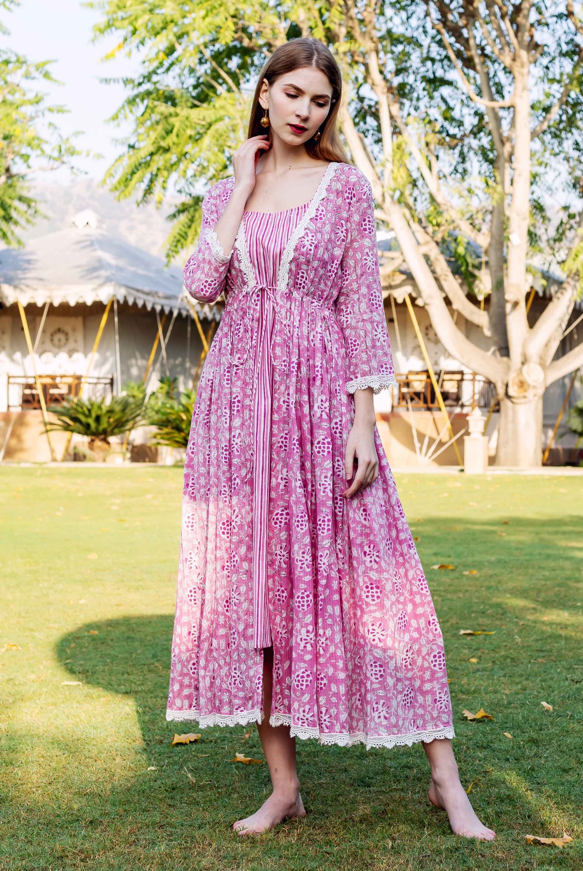 Front full-look of model in pink hand-block-printed ethnic floral jacket dress with stripes.