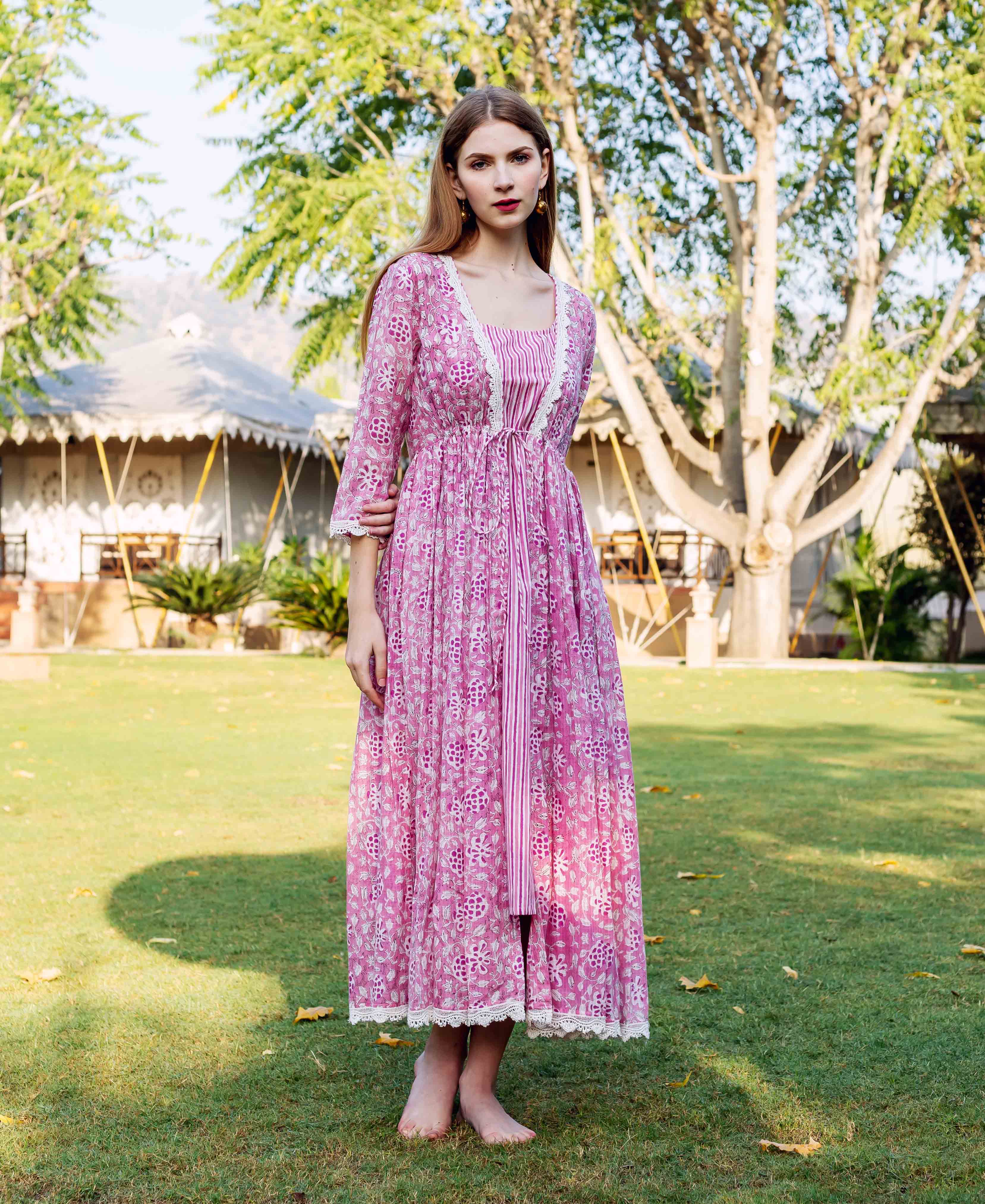 Front full look of model in pink hand-block-printed ethnic floral jacket dress.