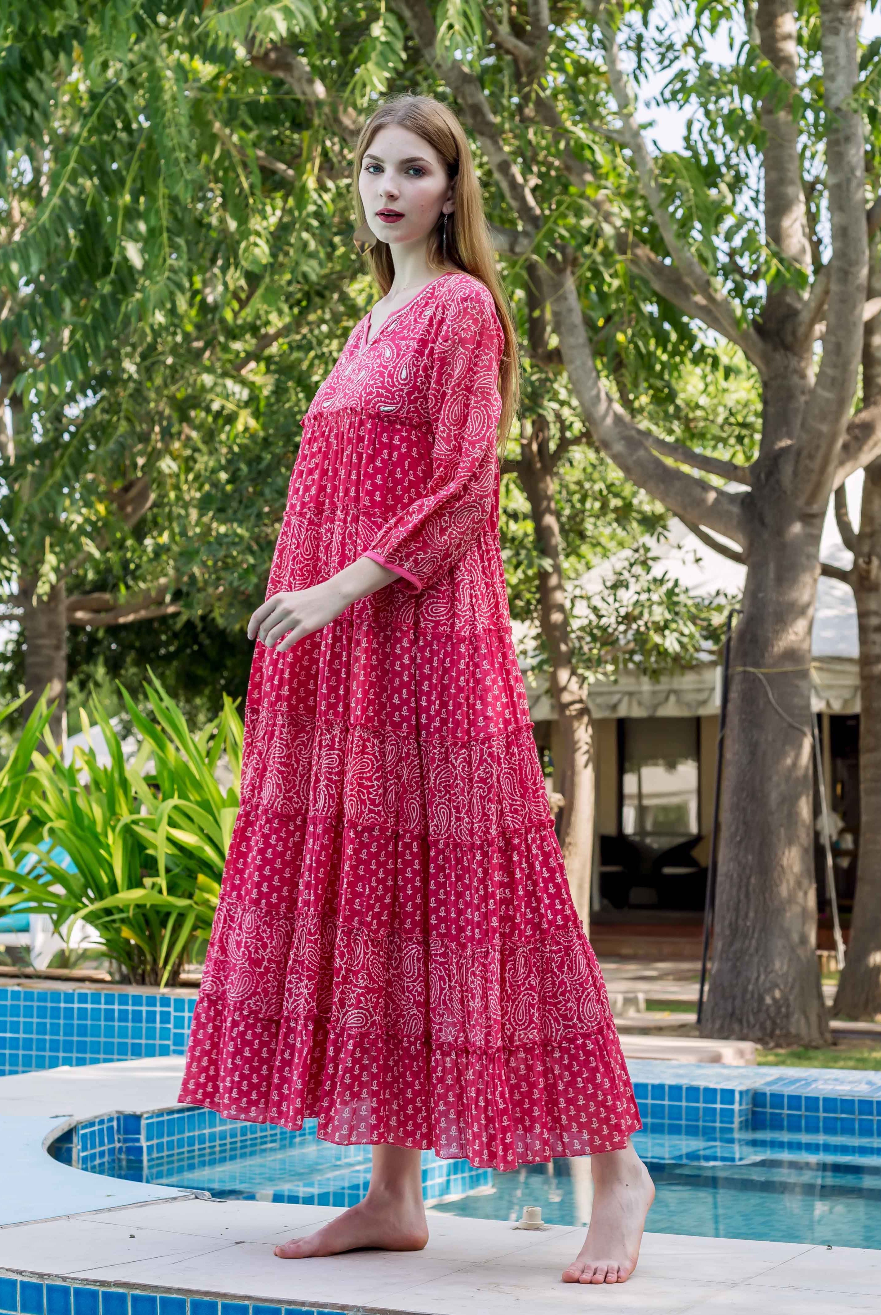 Model wearing vibrant pink tiered dress with white paisley hand-block print.