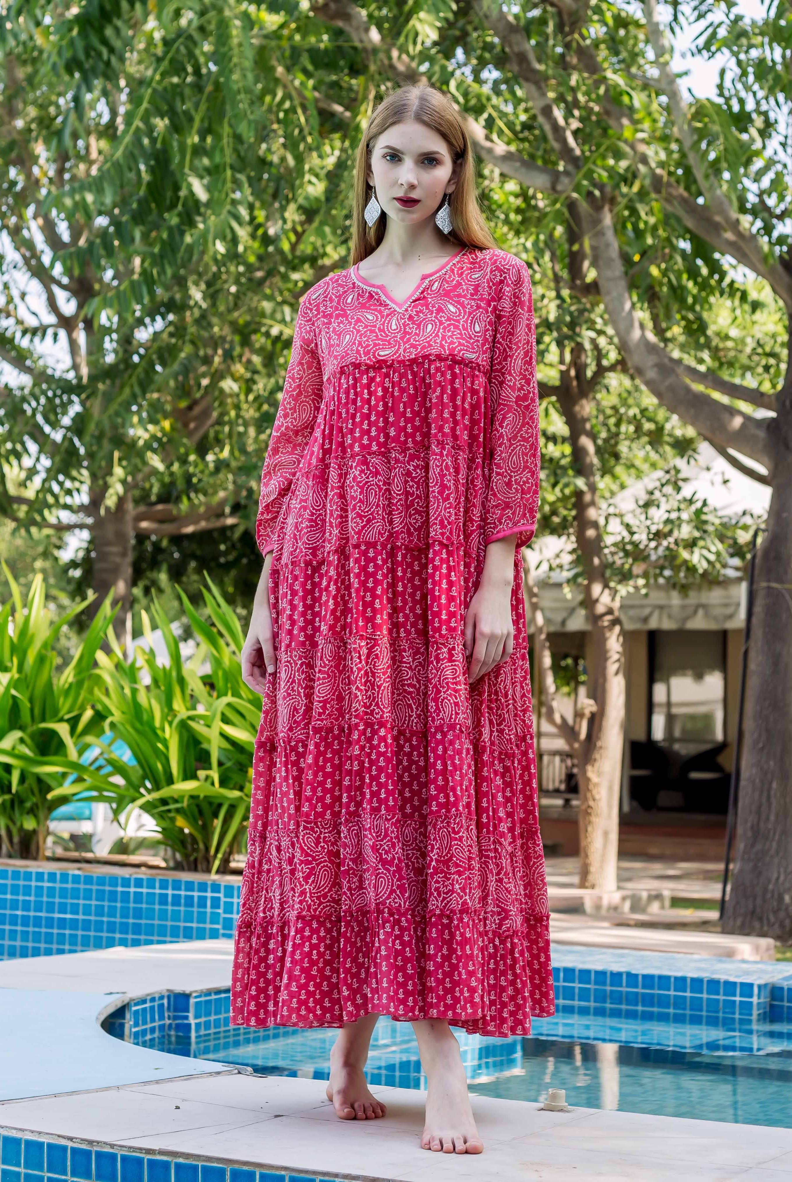 Model in a fuchsia tiered dress with embroidered V-neck and white ethnic hand-block prints.