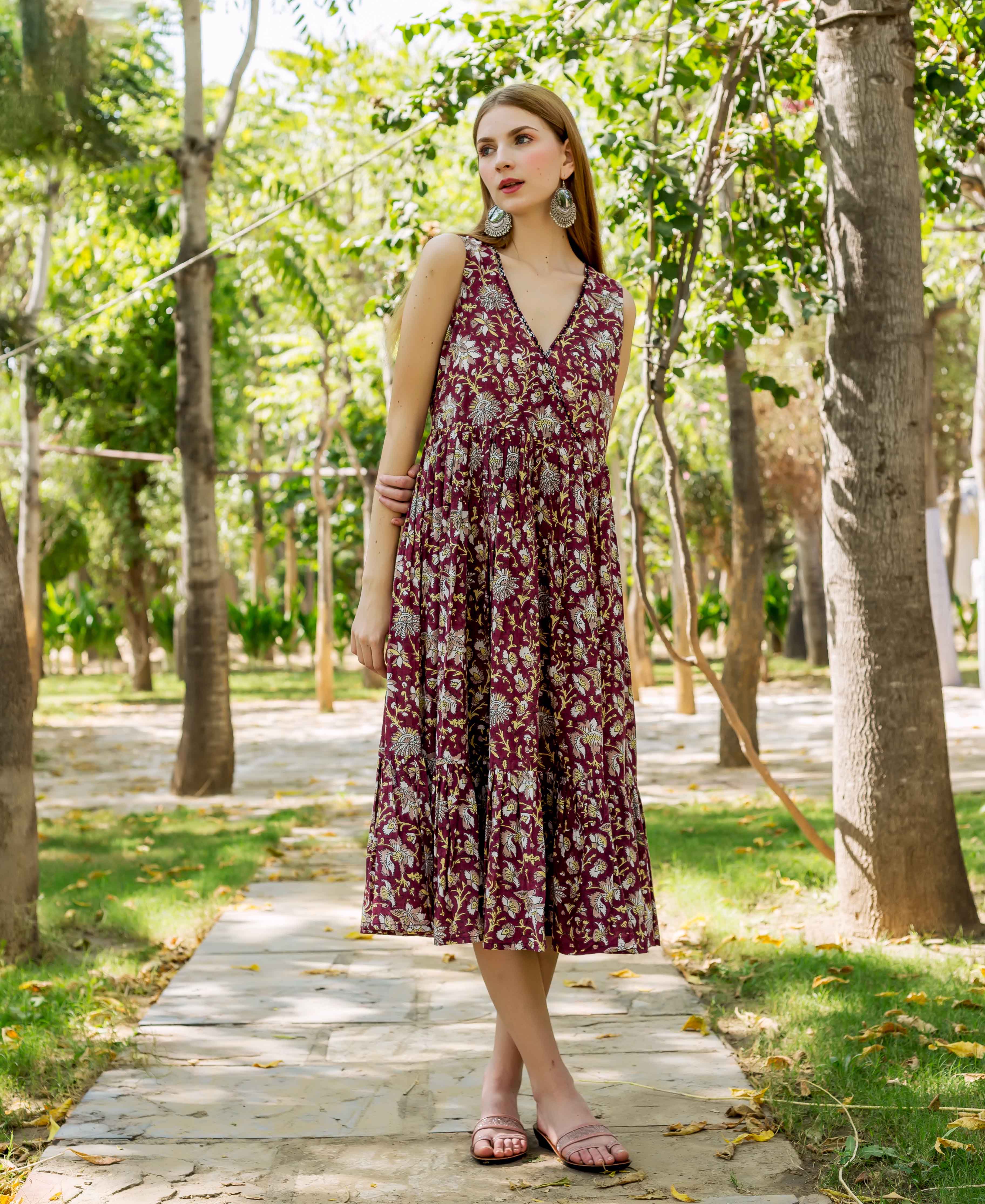 Maroon hand-block-printed floral tiered dress with V-neck worn by a standing model.