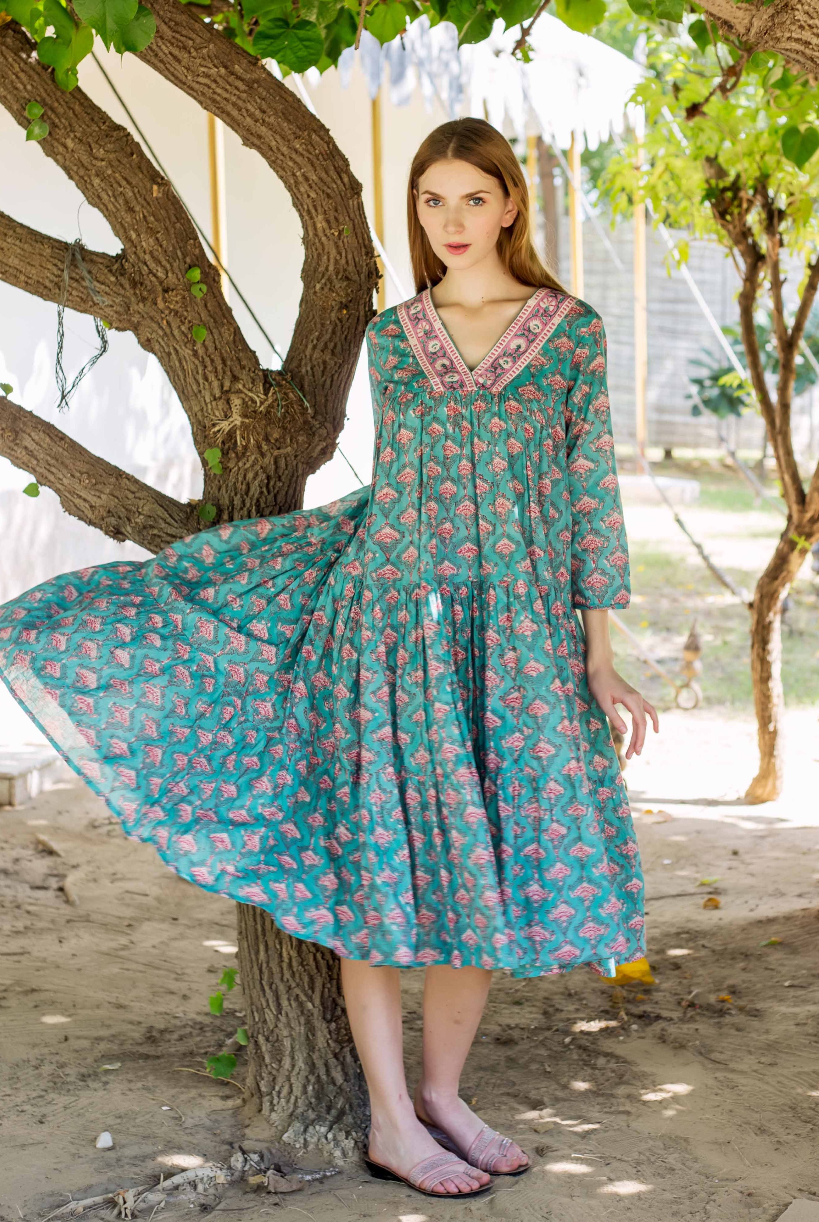 Full-length front of model in Eliza Green tiered dress with pink hand-block print.
