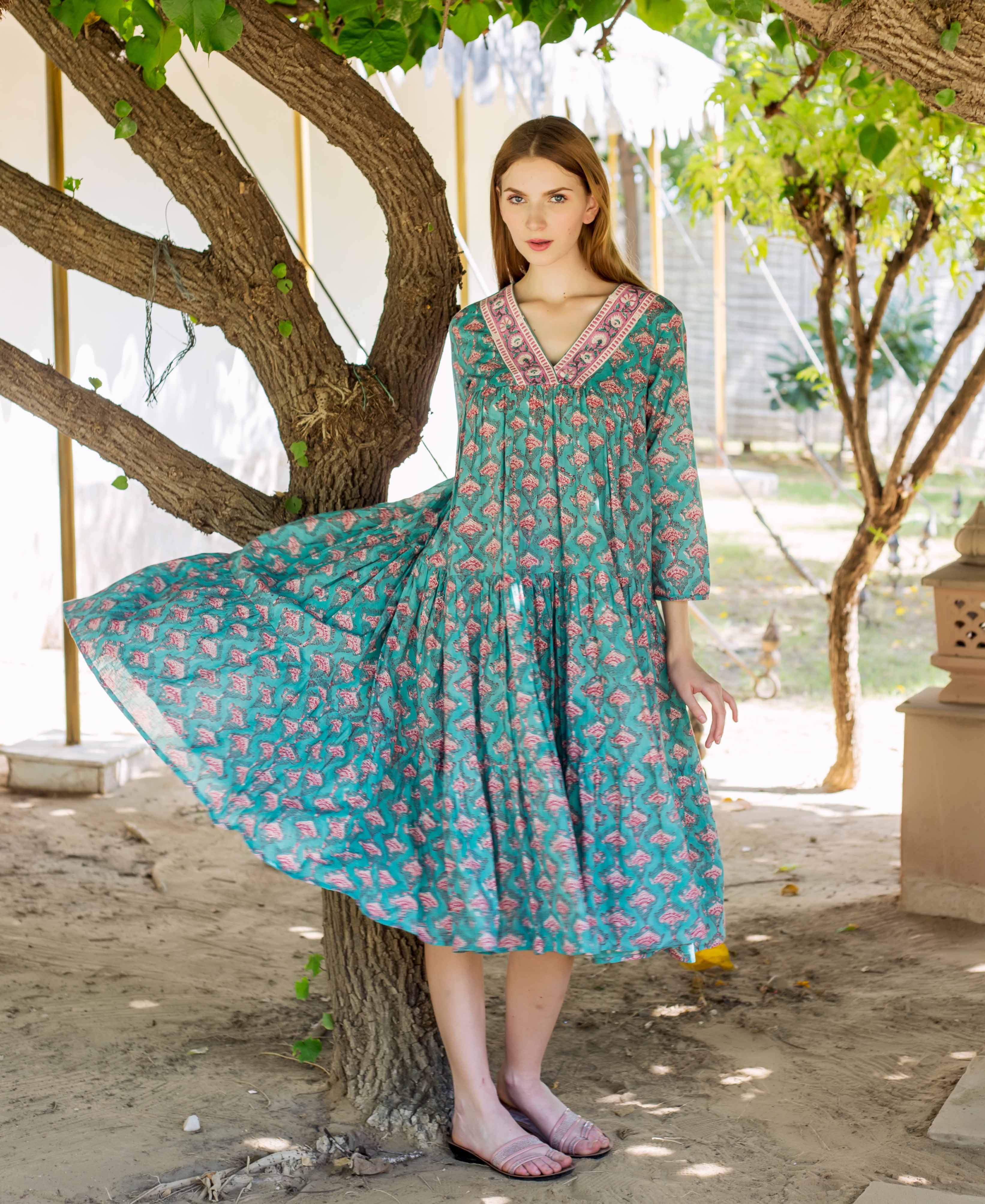 Full-length front of model in Eliza Green tiered dress with pink hand-block print.
