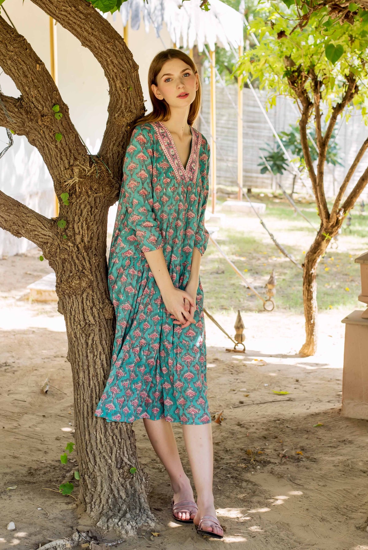 Full look of model in teal and pink hand-block-printed tiered ethnic dress.