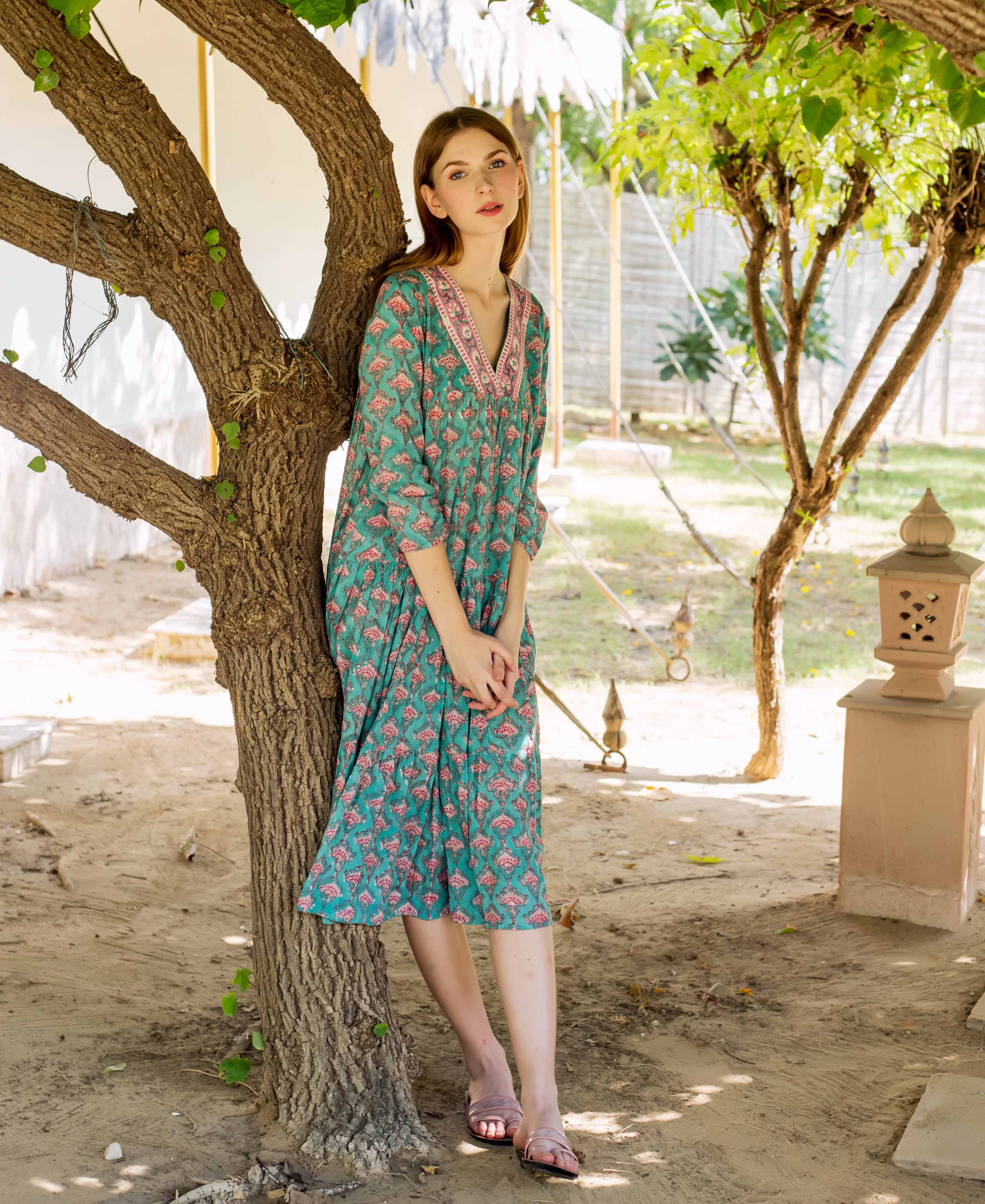 Full look of model in teal and pink hand-block-printed tiered ethnic dress.