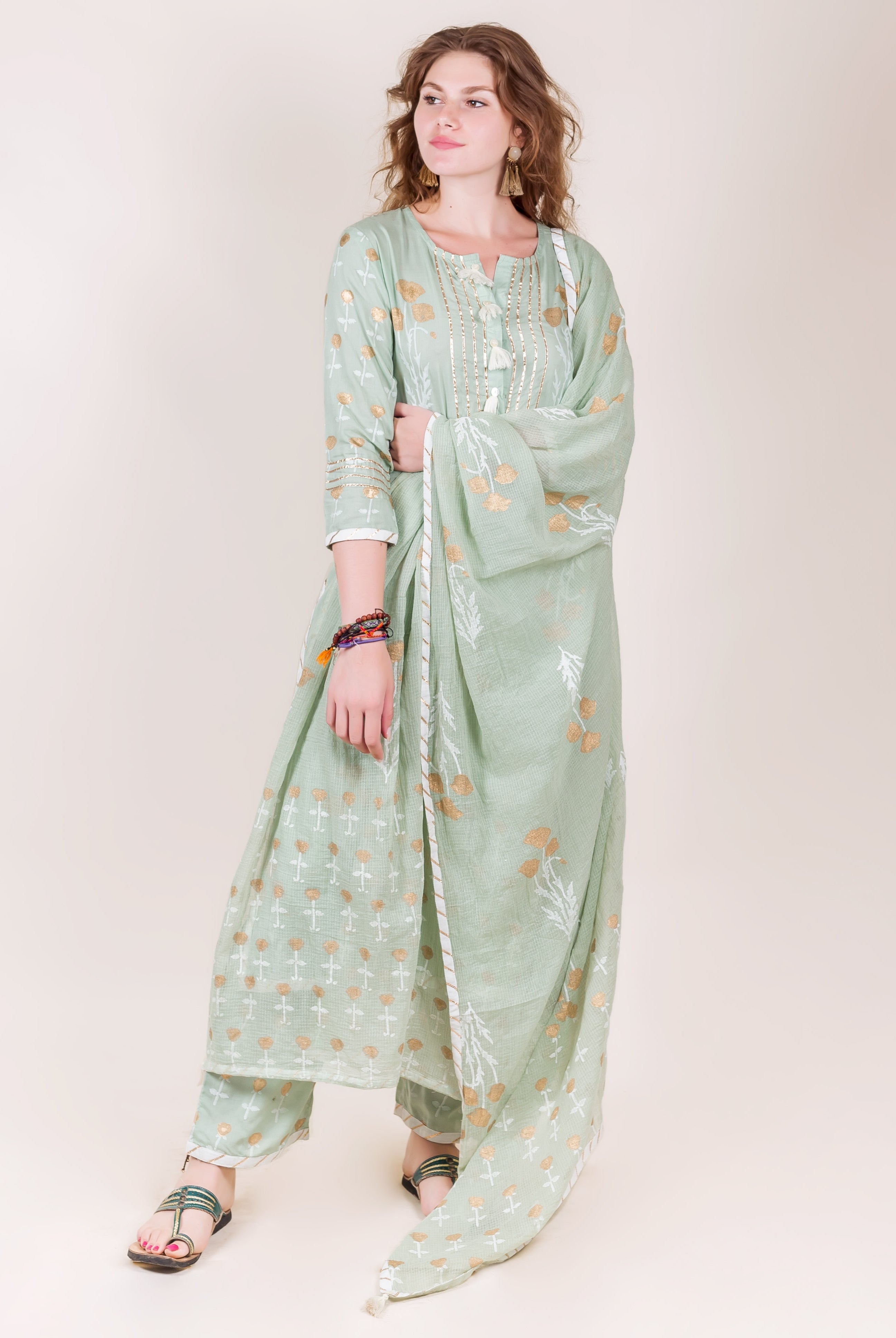 A model wearing a mint green kurta with gold and white block prints.