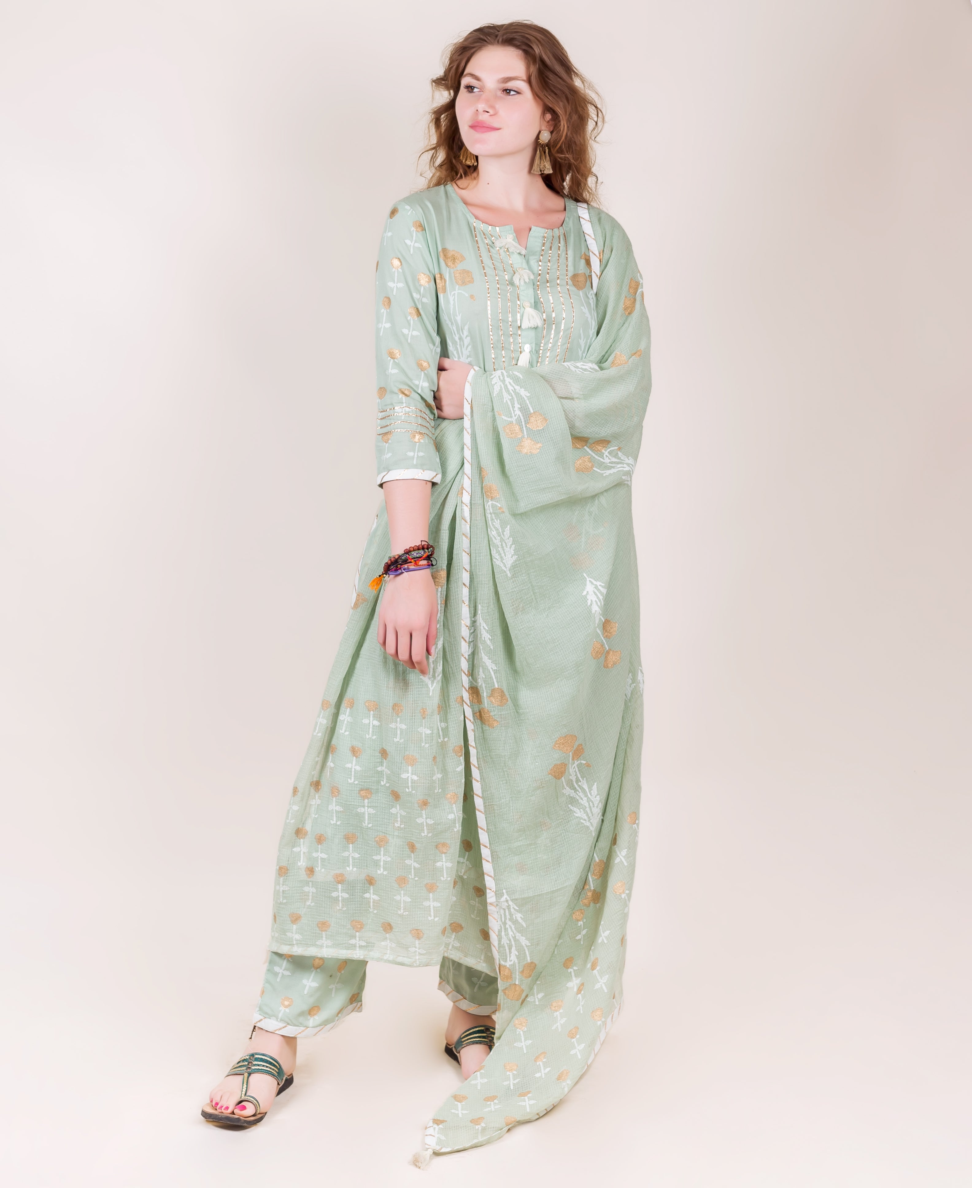 A model wearing a mint green kurta with gold and white block prints.