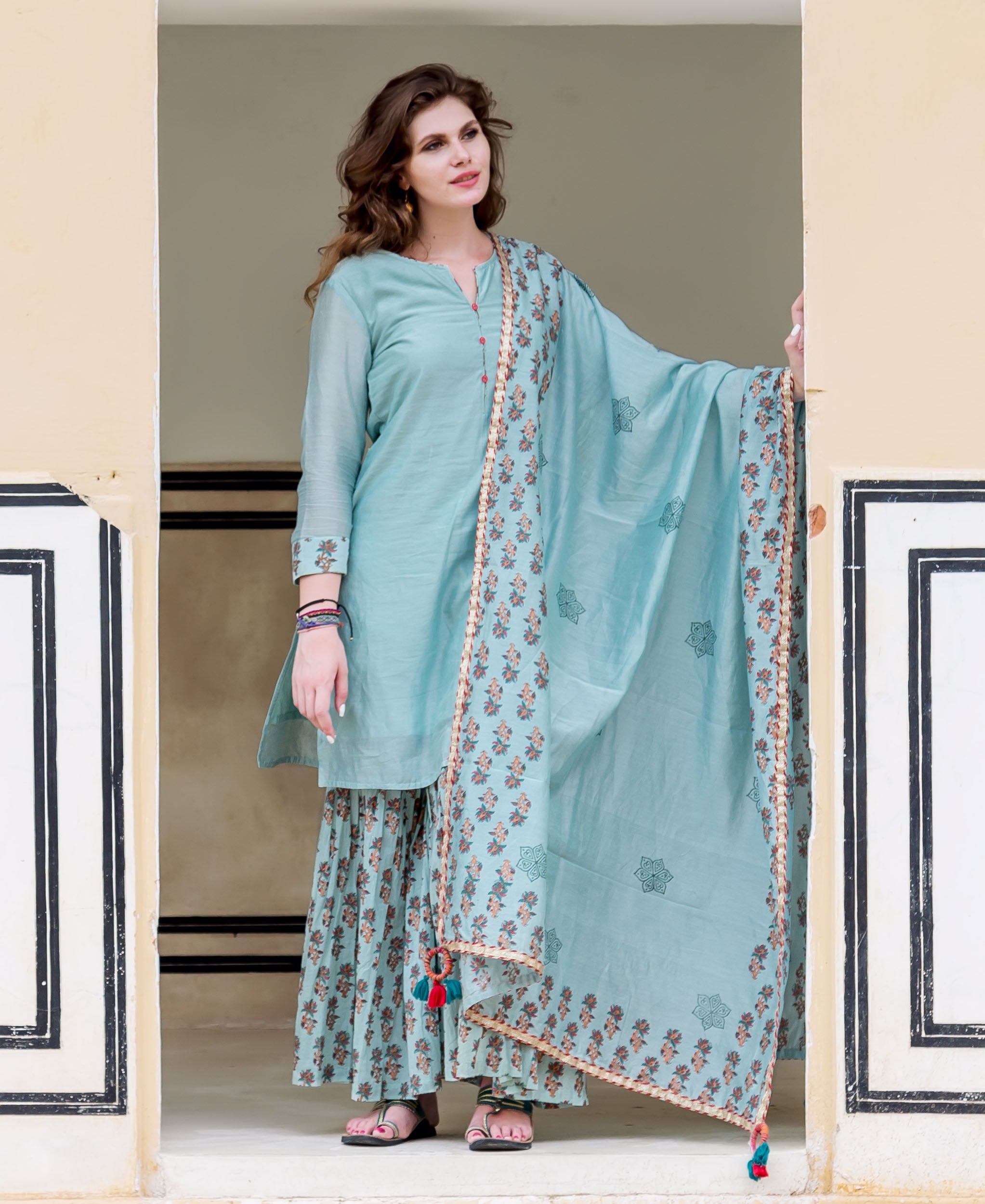 Front view model: Solid ice blue kurta, hand-block printed sharara, and matching dupatta.