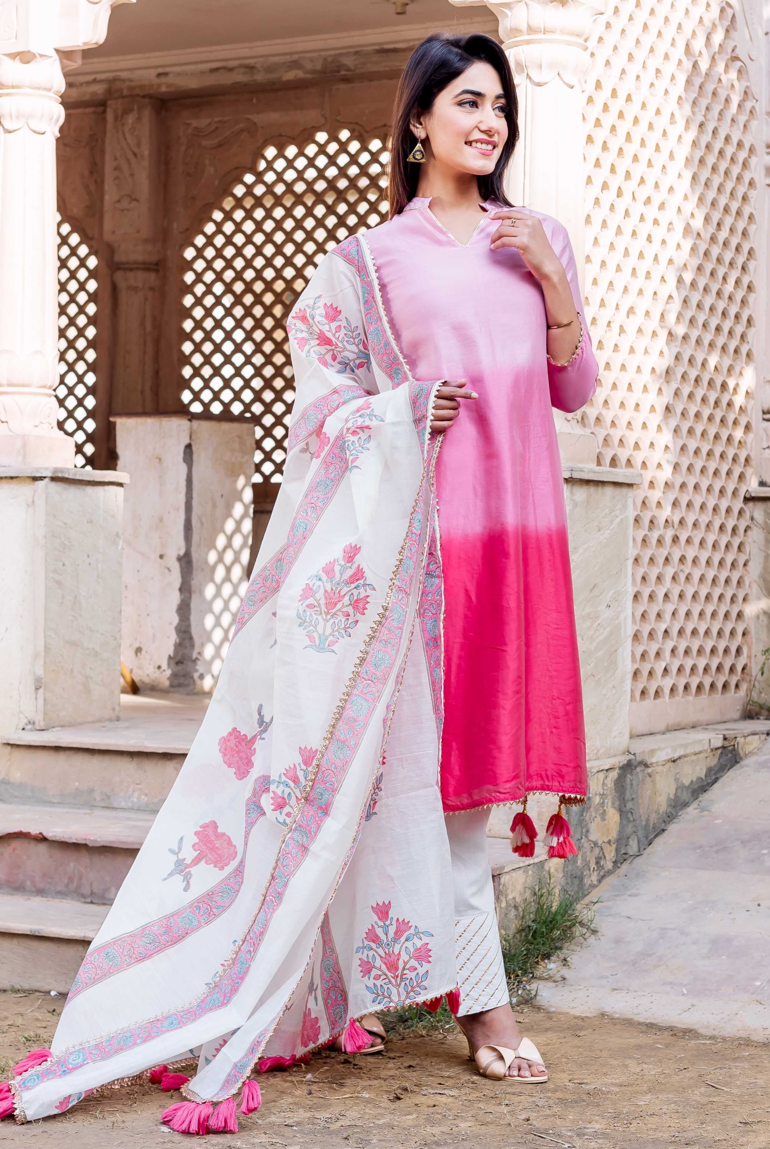 Model in ombre pink kurta, white hand-block printed pants, and floral dupatta.
