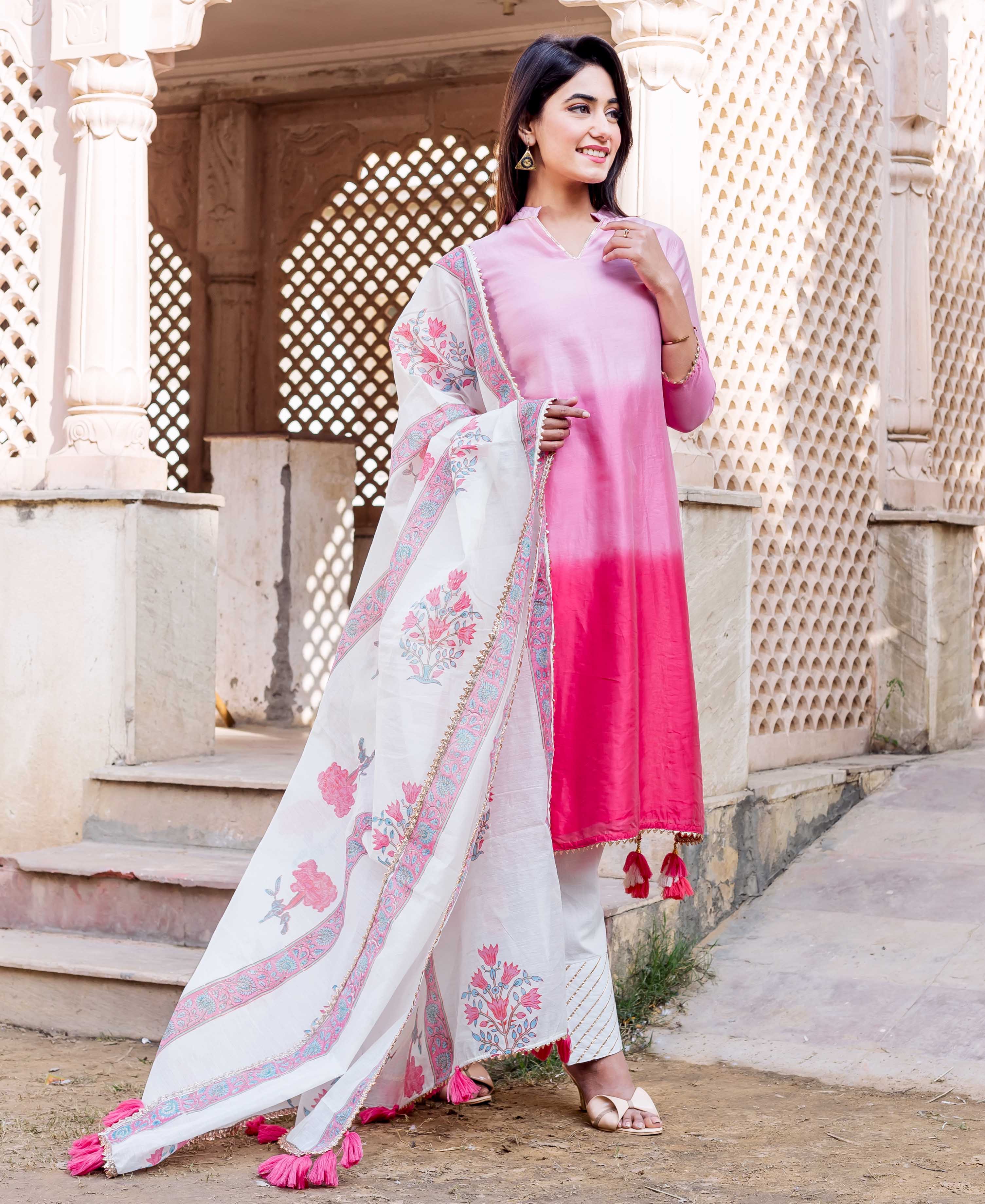Model in ombre pink kurta, white hand-block printed pants, and floral dupatta.